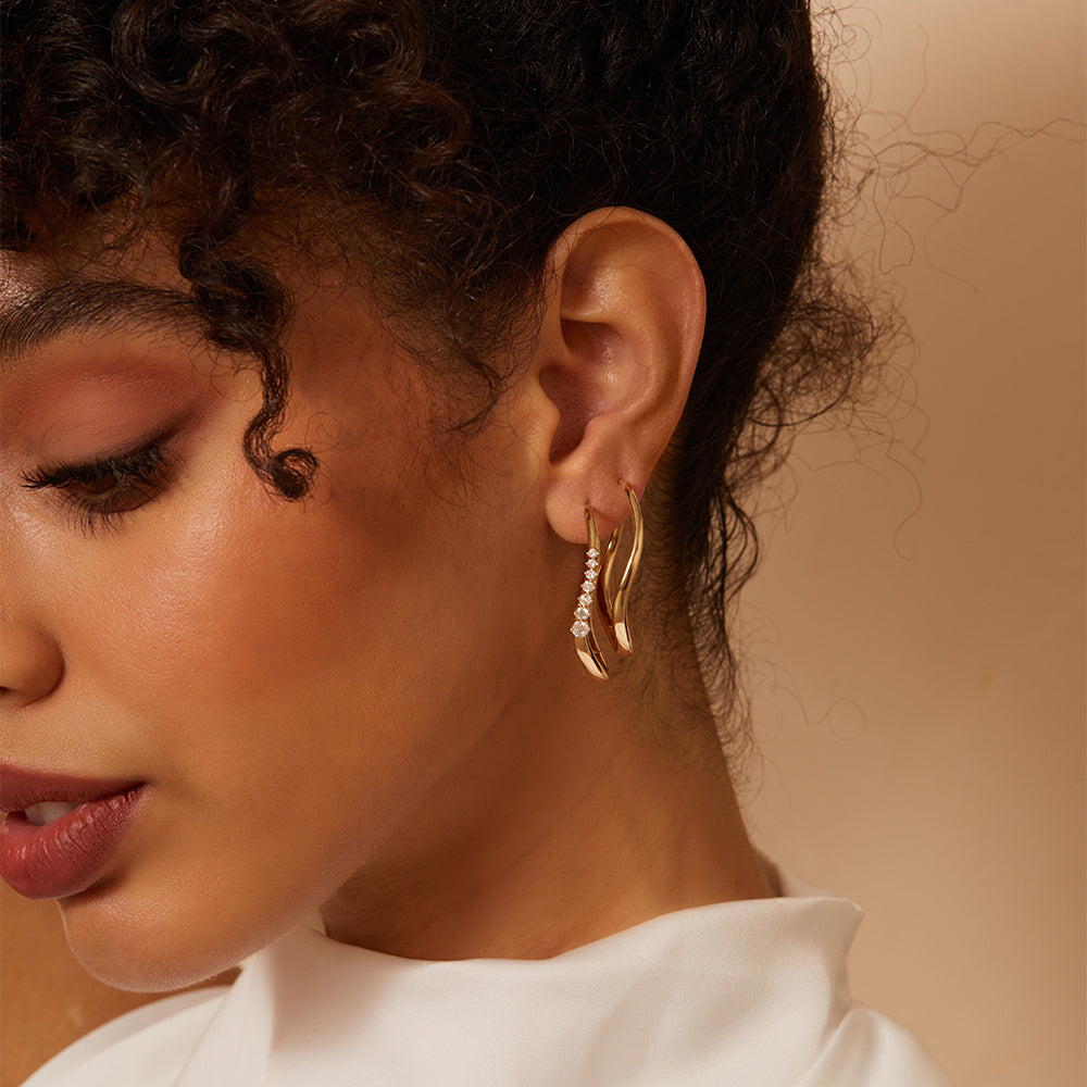 Large Melt Hoops ML-E1 matte and shiny gold hoop earrings with sparkle stones along the rim.