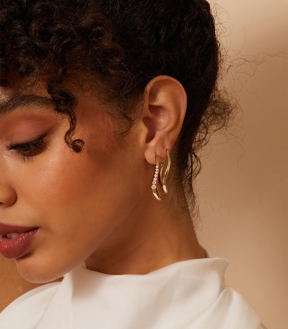 Large Melt Hoops ML-E1 matte and shiny gold hoop earrings with sparkle stones along the rim.