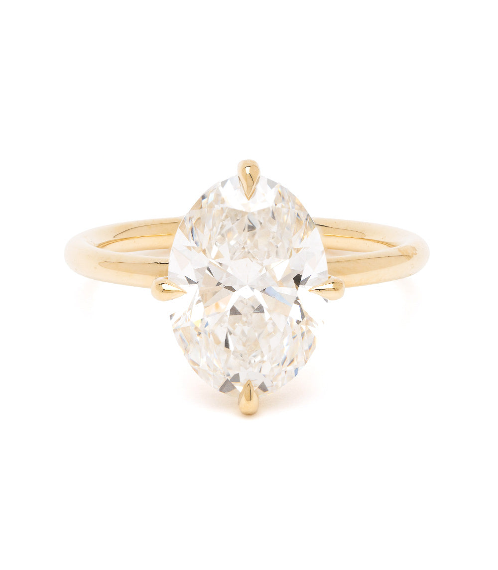 Billie Sofia Kaman gold engagement ring with polished band and oval cut diamond center