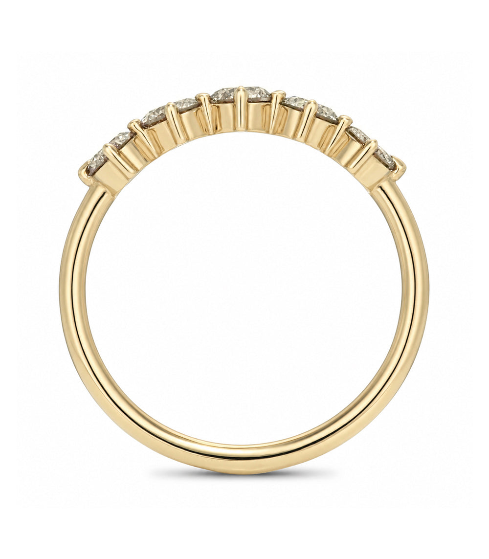 A yellow gold ring with a row of small clear gemstones set in a beaded pattern along the top, shown against a plain white background.