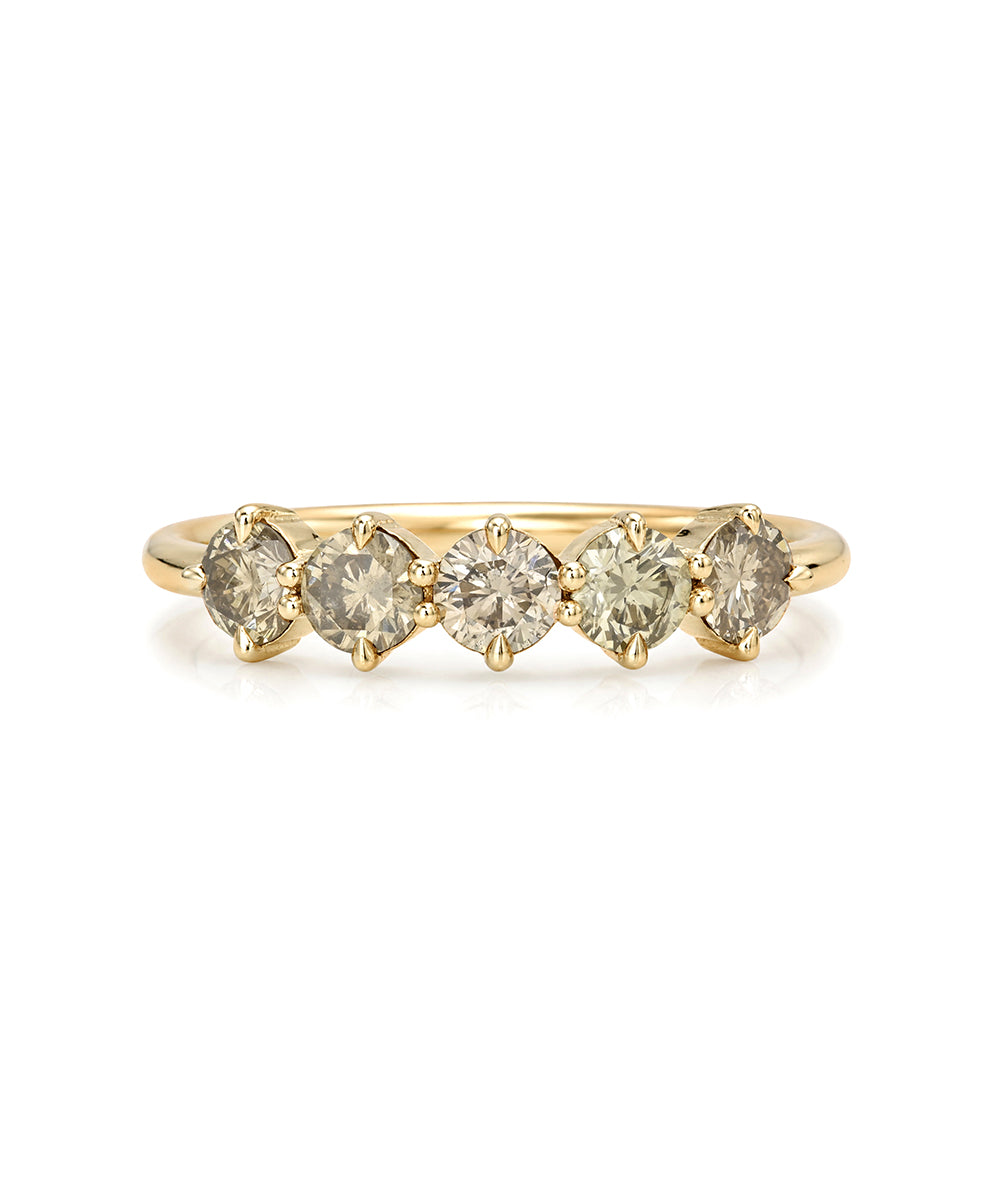 A yellow gold diamond band ring featuring five round-cut diamonds set in a row, shown against a plain white background.