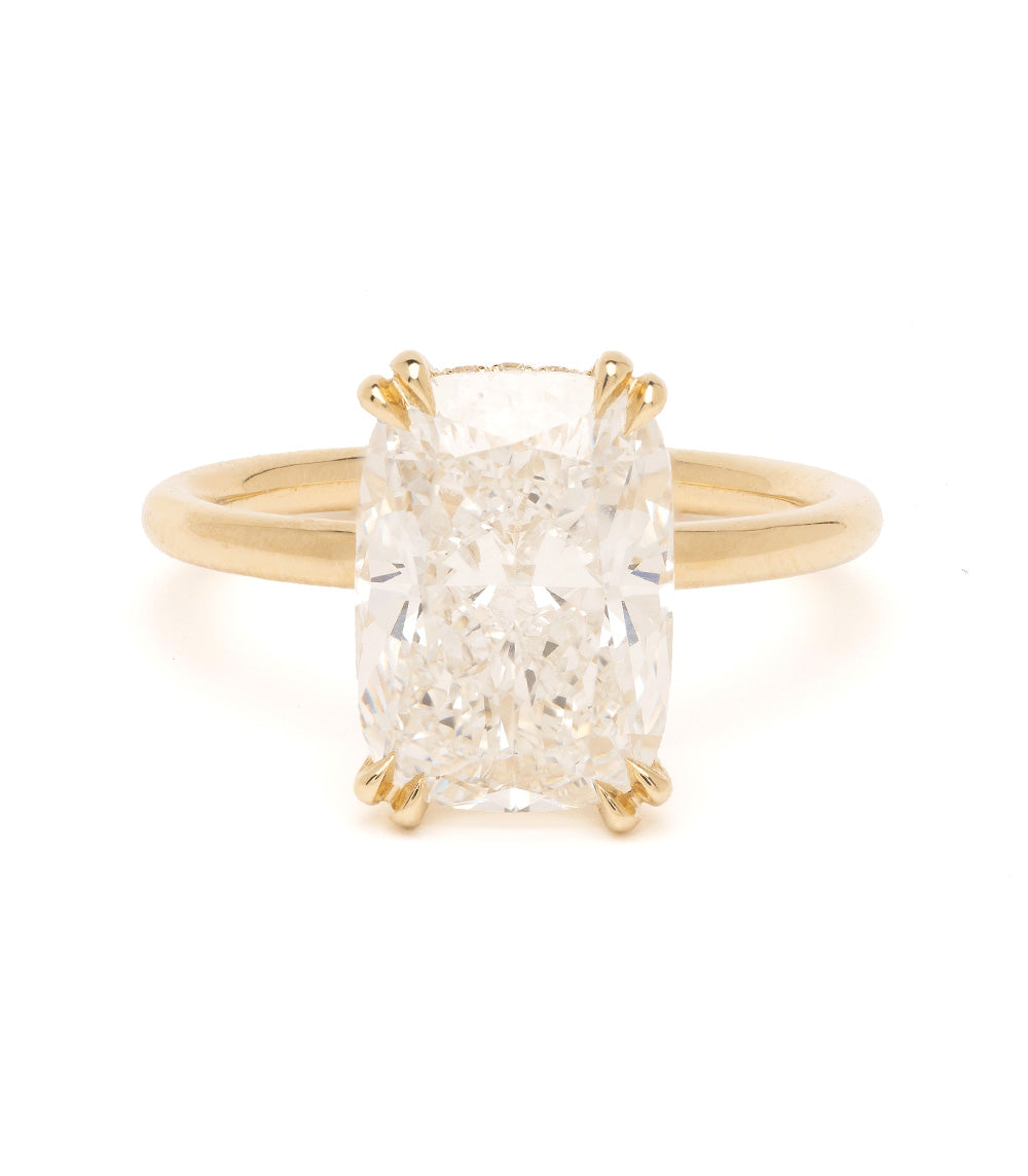 Gold ring with a large diamond on a white background