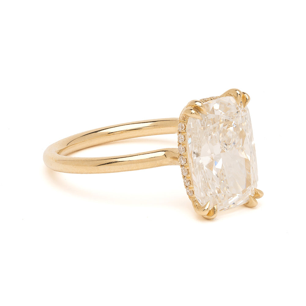 Gold ring with a large diamond on a white background