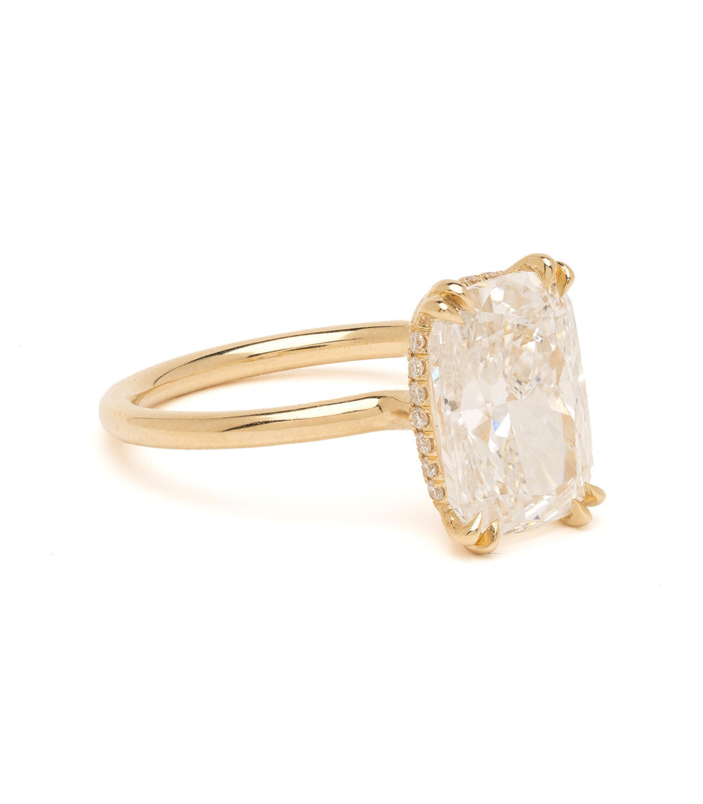 Gold ring with a large diamond on a white background