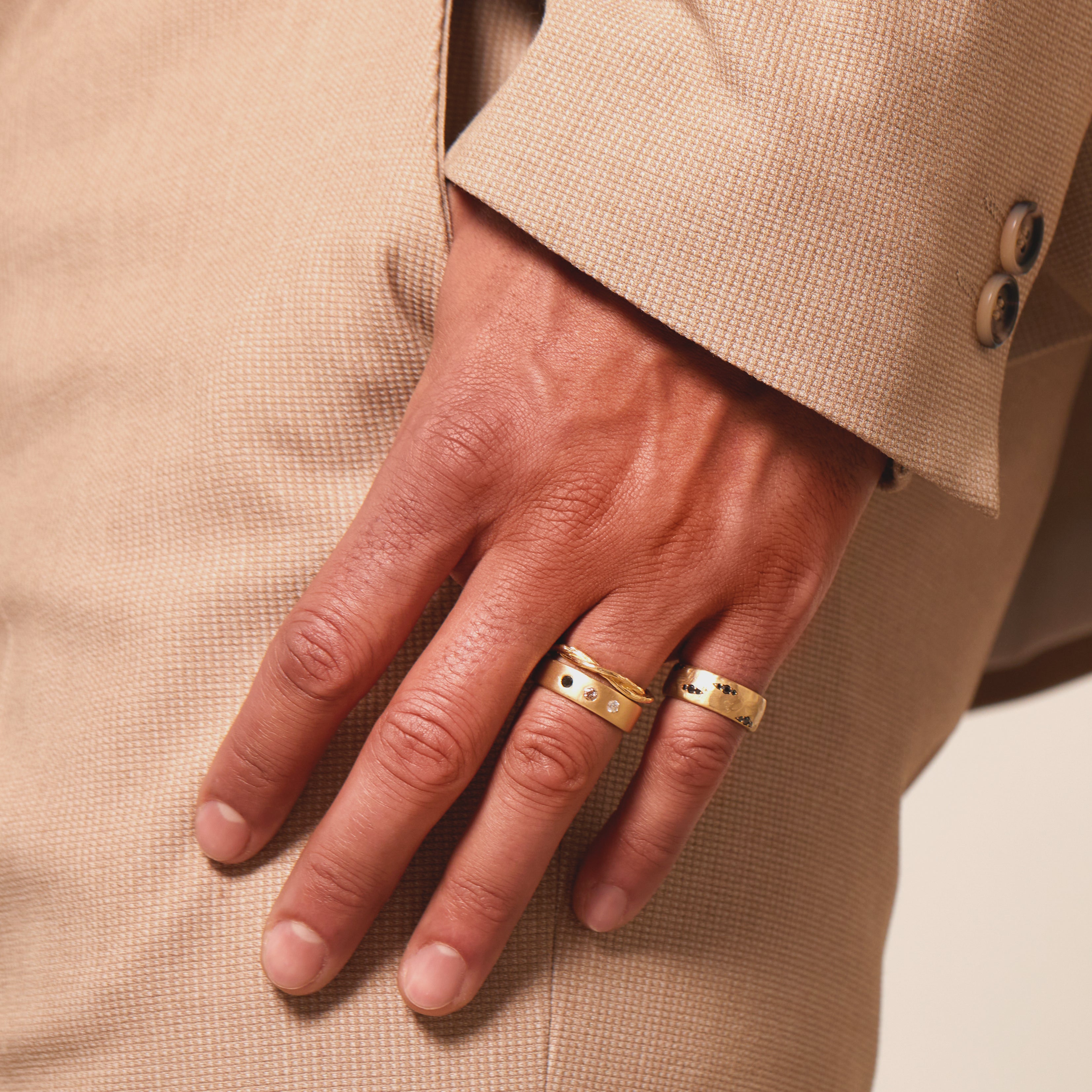 Dusk till Dawn II GN-R5 bands in shiny gold on hand, two slim rings with small clear stones