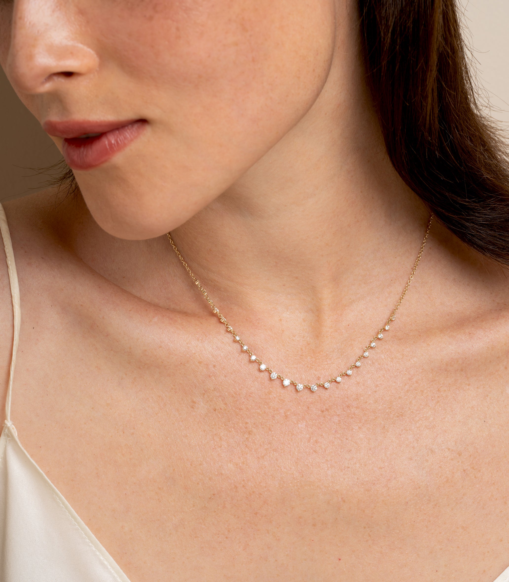 The Larchmont by CC-DN9 delicate gold necklace with small pavé diamonds, styled in soft studio light.