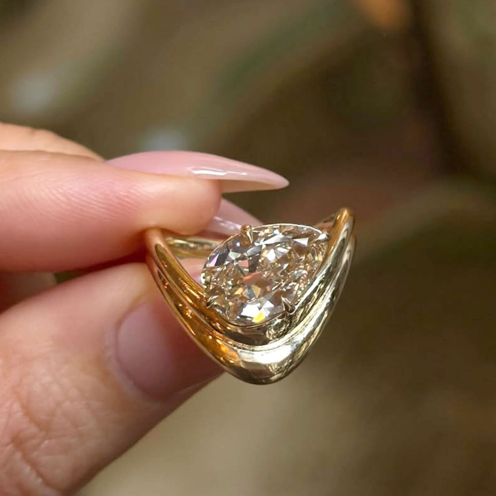 Double Melt Solitaire Sofia Kaman engagement ring in gold with unique engagement ring shine, asymmetrical engagement ring.