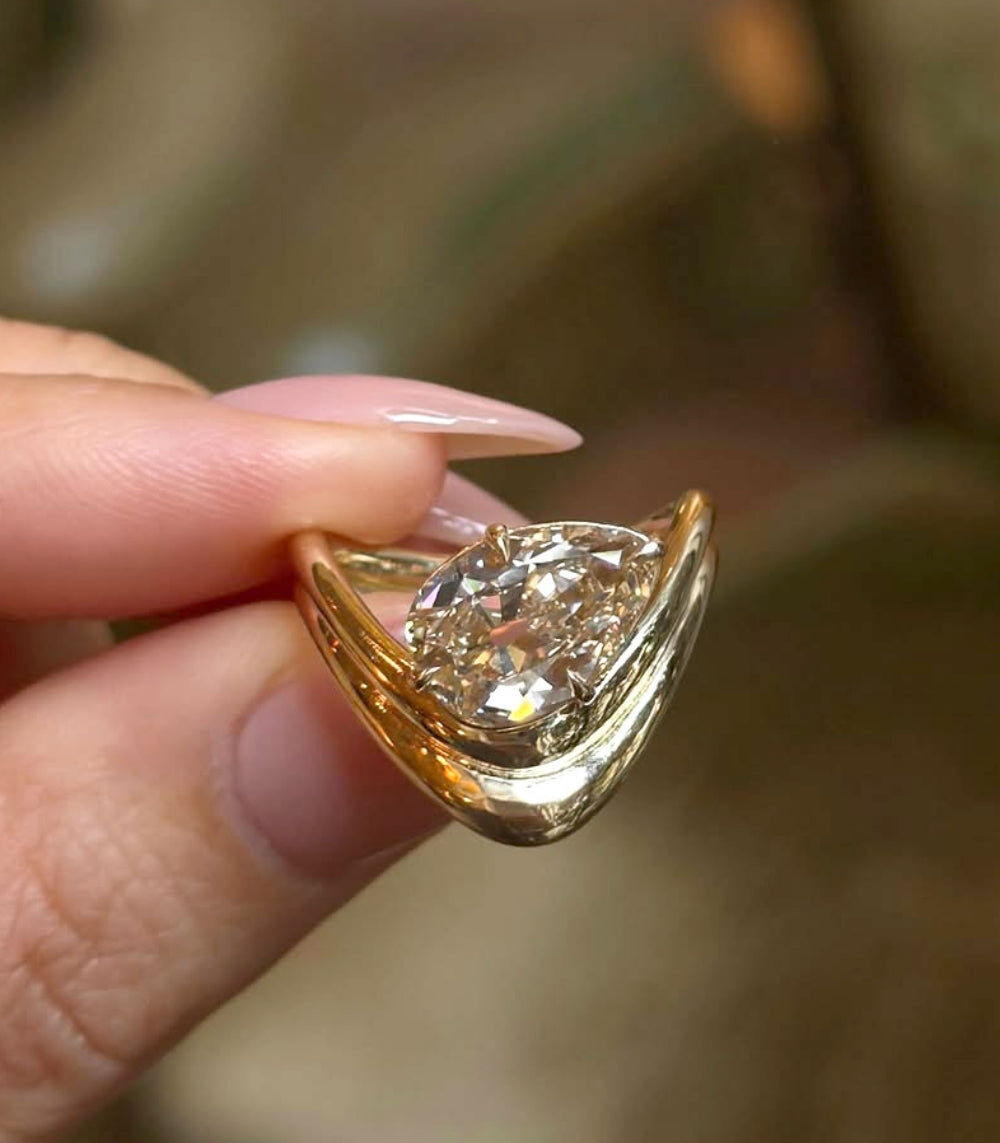 Double Melt Solitaire Sofia Kaman engagement ring in gold with unique engagement ring shine, asymmetrical engagement ring.
