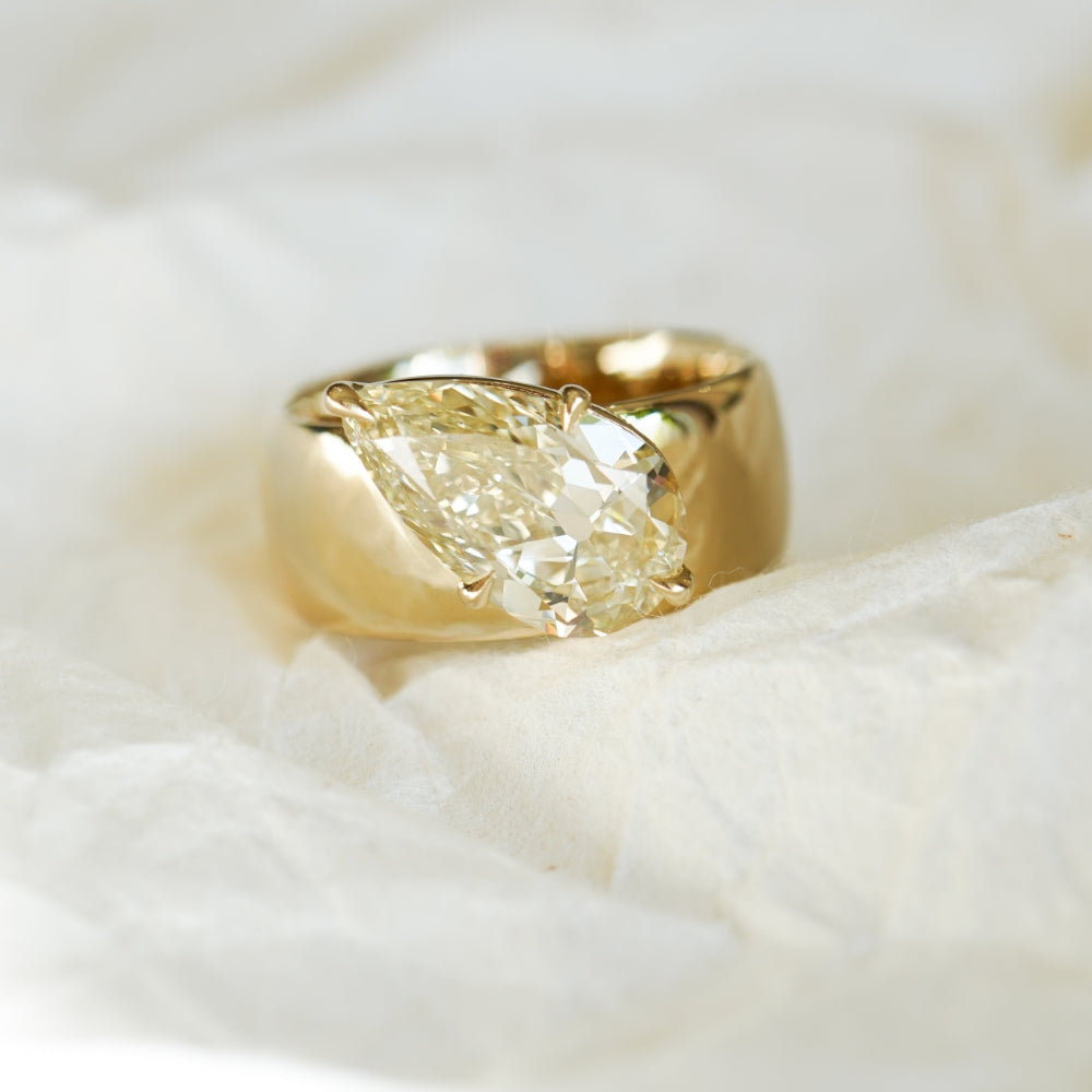 Lana by Sofia Kaman gold ring with cushion-cut diamond center on soft white fabric