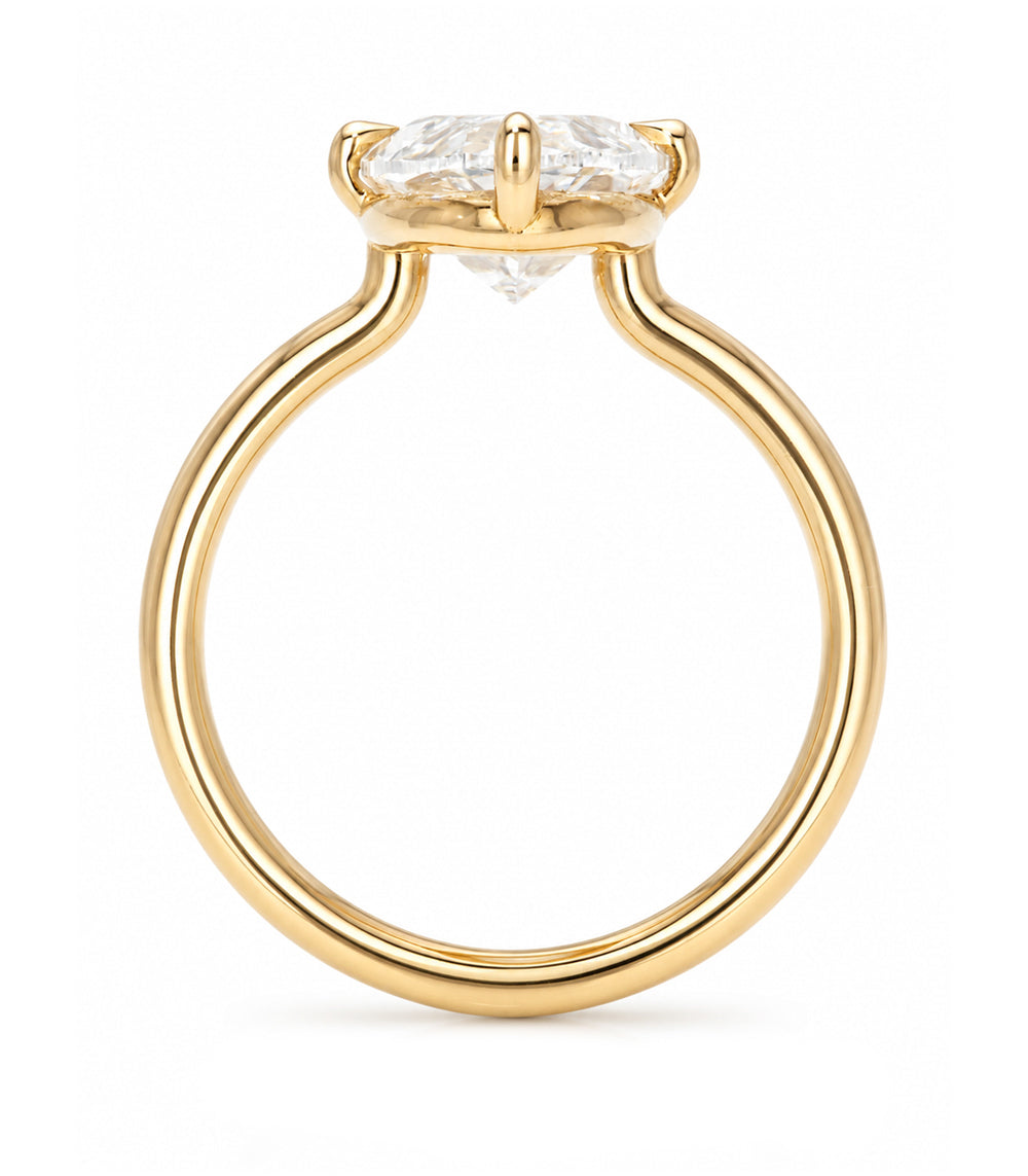 A yellow gold solitaire engagement ring featuring a oval brilliant-cut white diamond in a prong setting, shown on a clean white background.