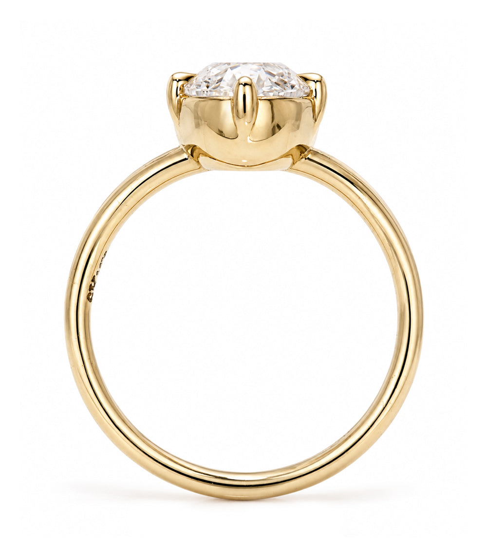 A yellow gold solitaire engagement ring featuring a moval old mine-cut white diamond in a bezel split shank setting, shown on a clean white background.