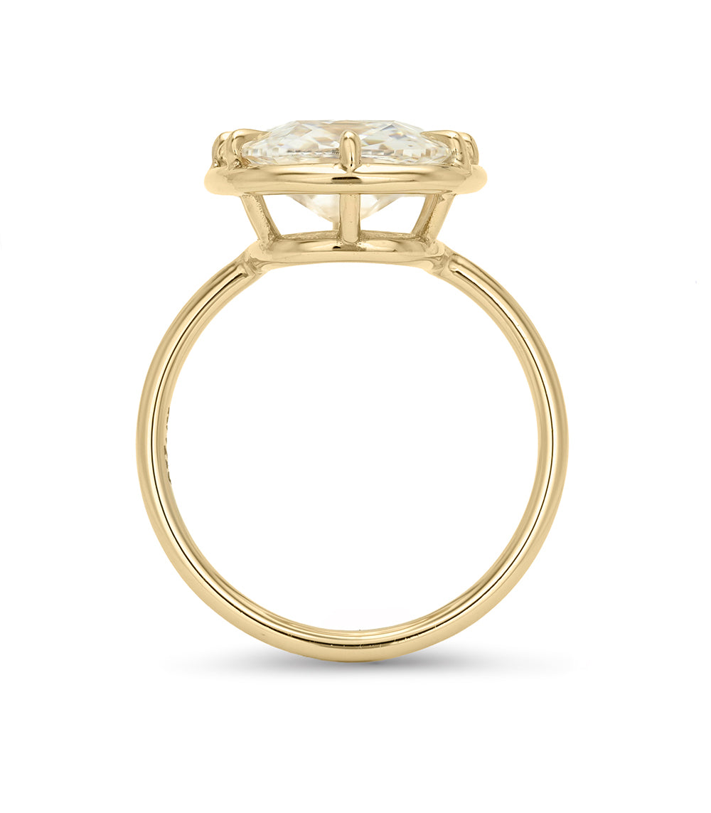 A yellow gold diamond ring with a large elongated cushion diamond set in a eight-prong crown on a polished shank, shown against a plain white background.