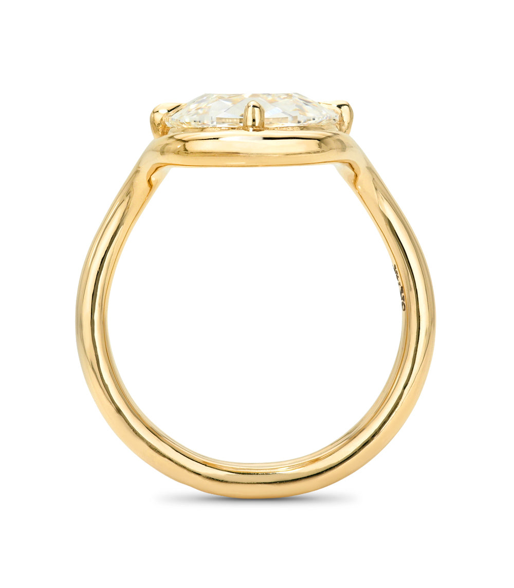 A yellow gold ring with a wide, polished band and a cushion-cut diamond center stone in a four-prong setting, shown against a plain white background.