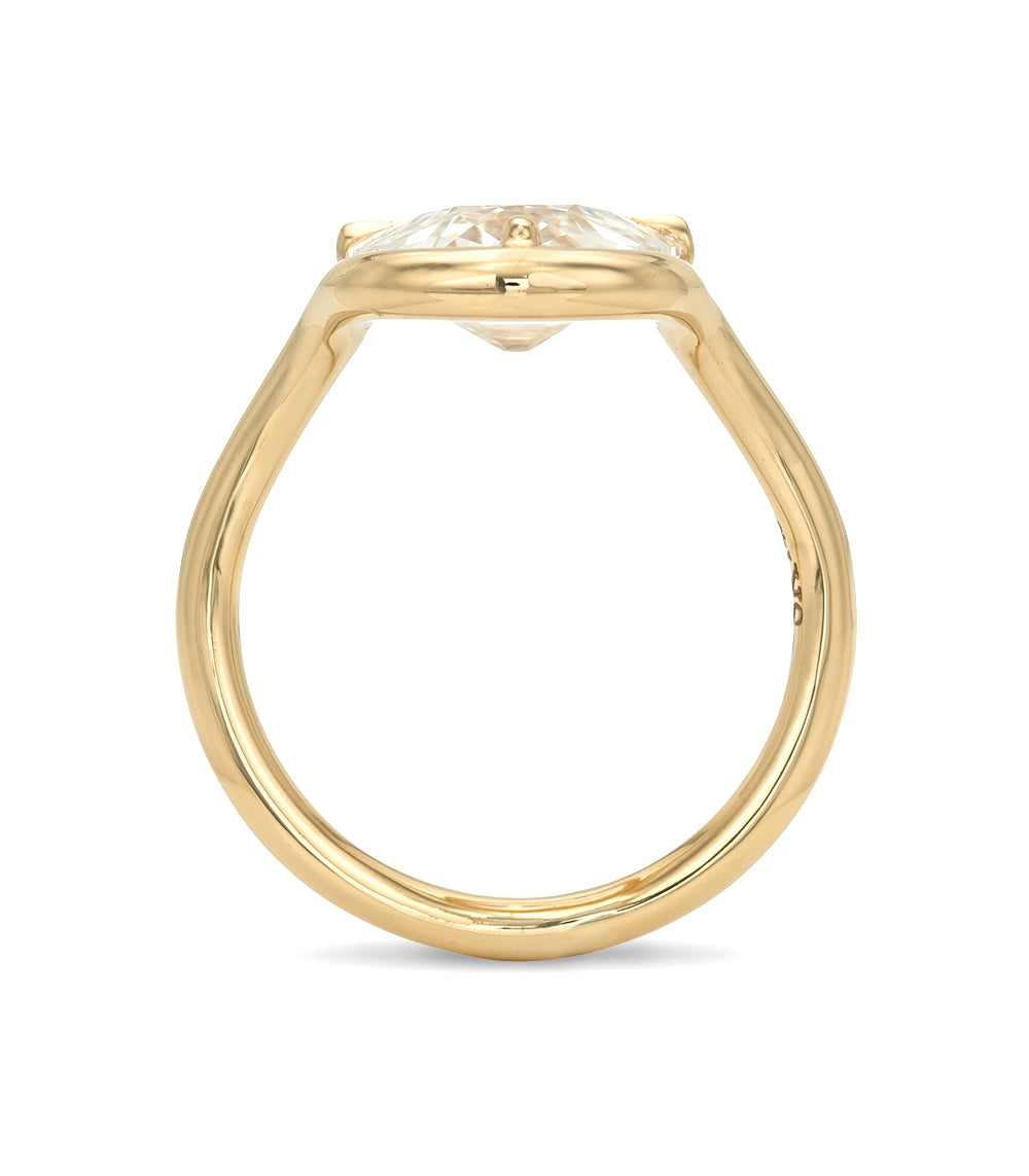 Gold ring with a large diamond on a white background