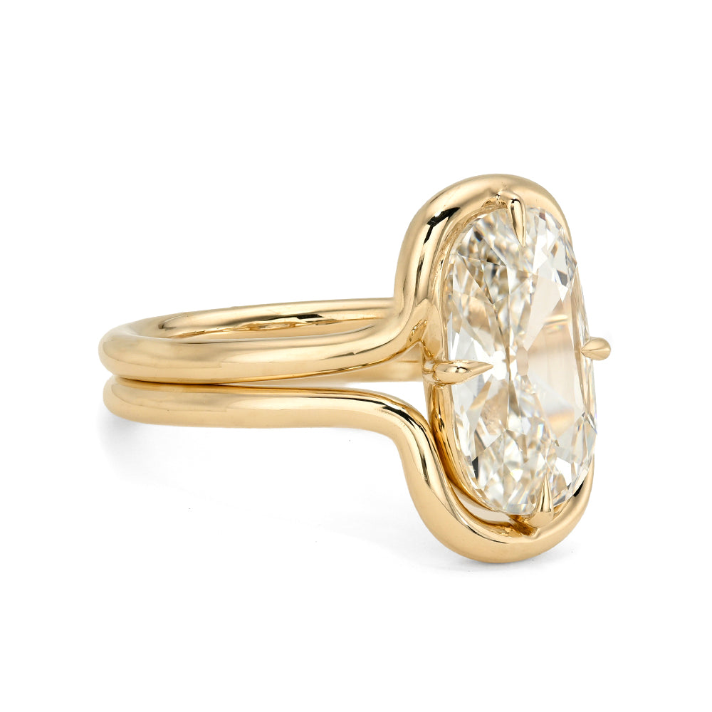Gold ring with a large diamond on a white background