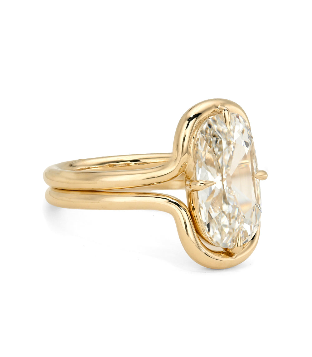 Gold ring with a large diamond on a white background