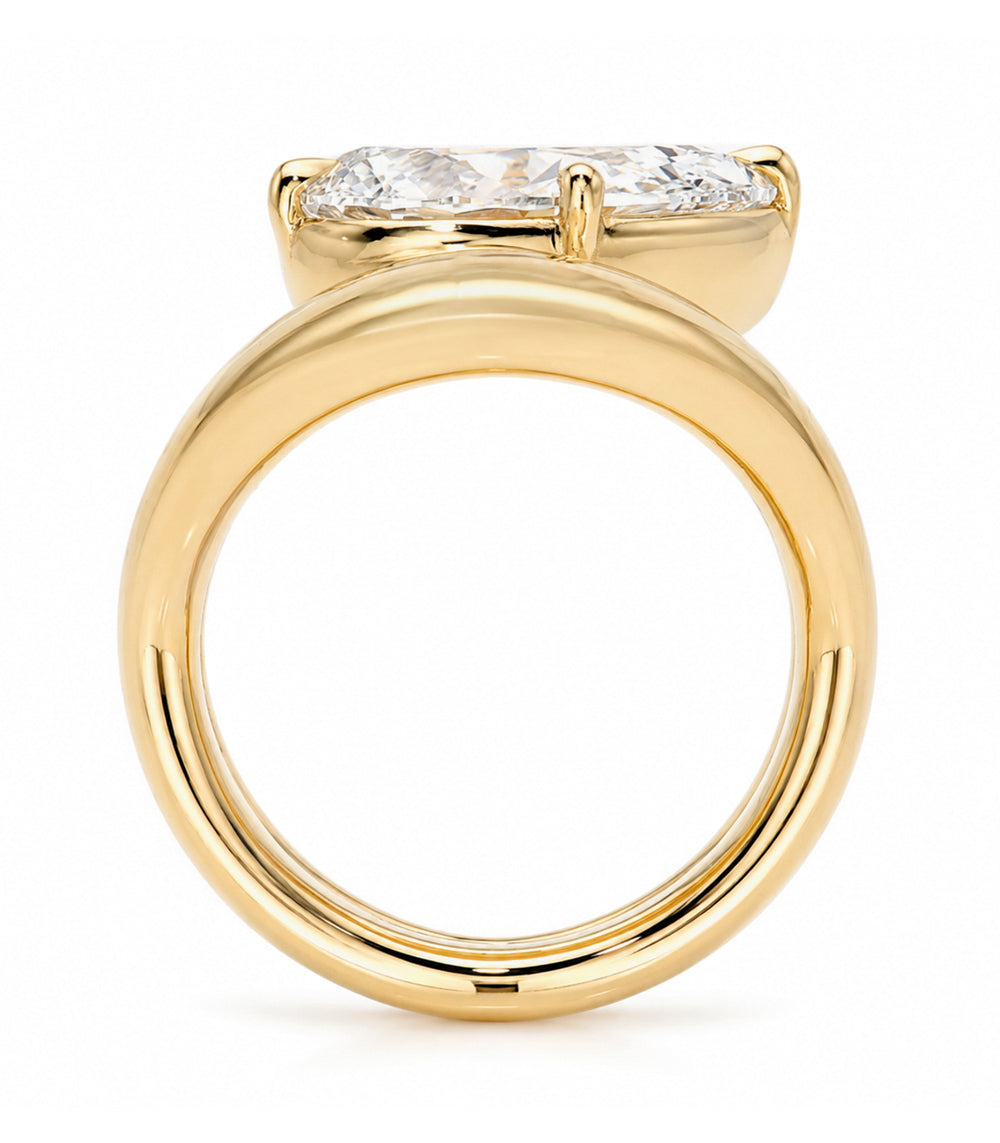 A yellow gold solitaire double melt engagement ring featuring a pear brilliant-cut white diamond in a prong setting, shown on a clean white background.