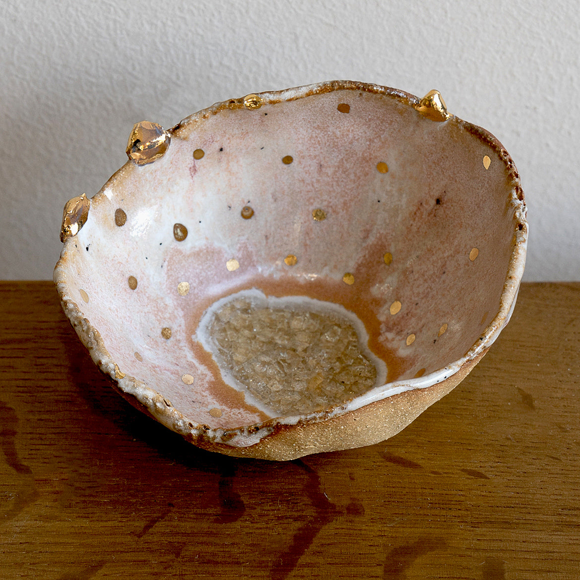 Northern Lights Ring Dish G-005 gold-speckled ceramic ring dish with small prong accents on wood