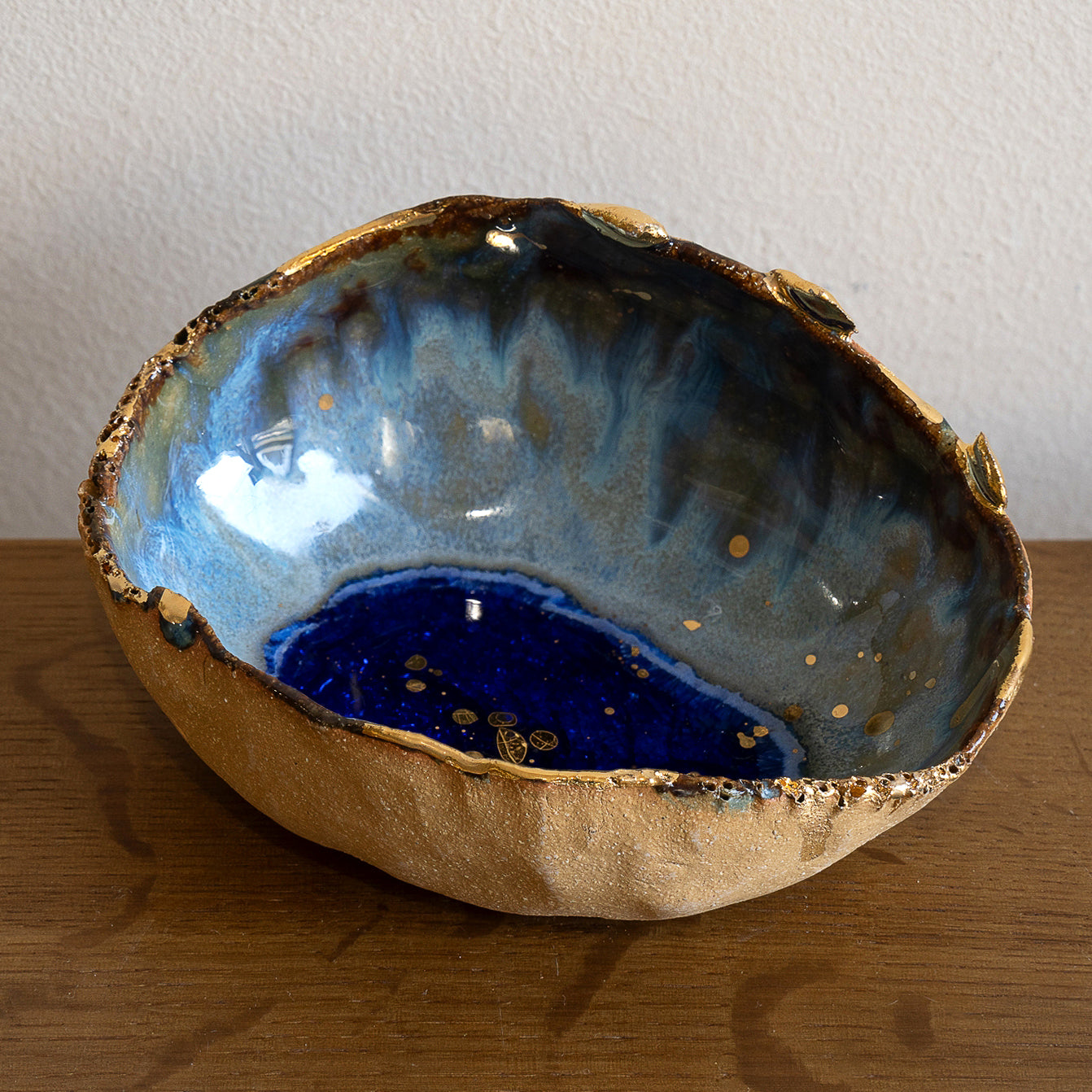 Azure Ring Dish by G-007, gold and blue resin ring dish with textured wave-like inner tray.