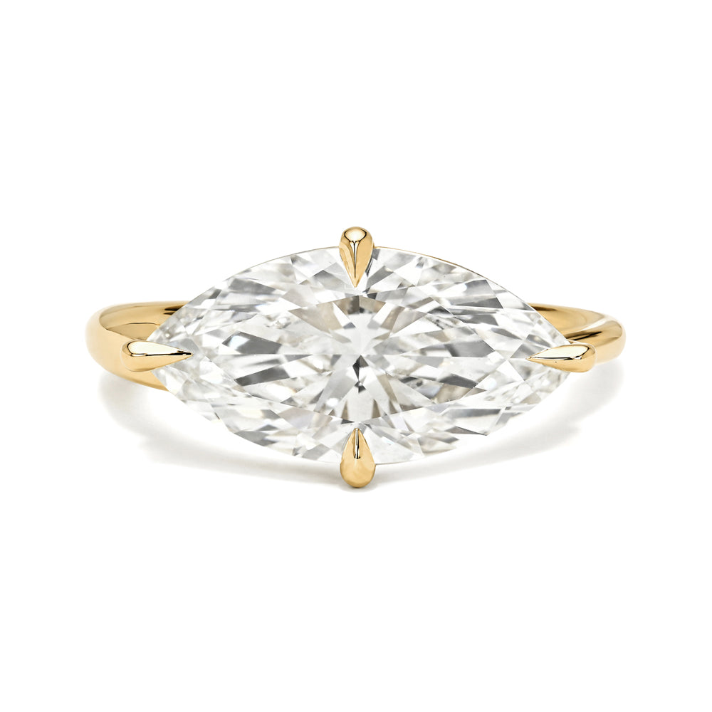 Gold ring with a large diamond on a white background
