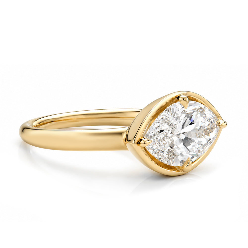A yellow gold ring featuring a marquise-cut diamond in a prong setting, shown on a clean white background.