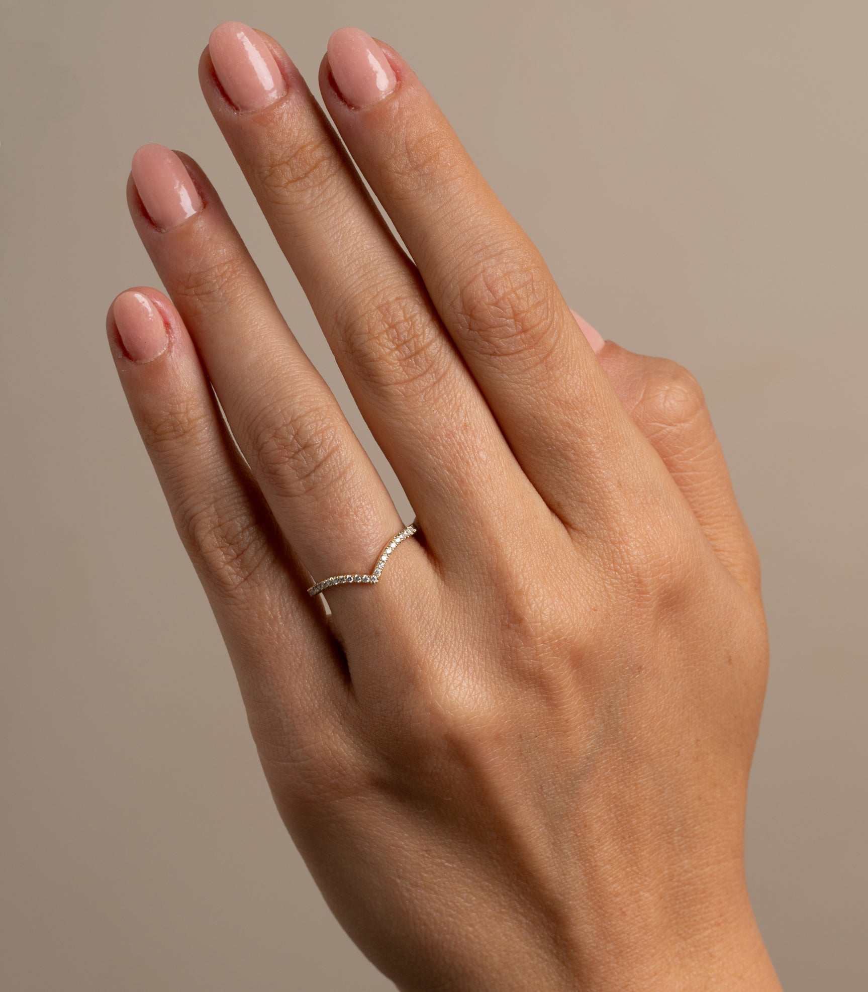 Mini Chevron Band by A-R1-P, 14K yellow gold chevron band on fingers in soft studio light