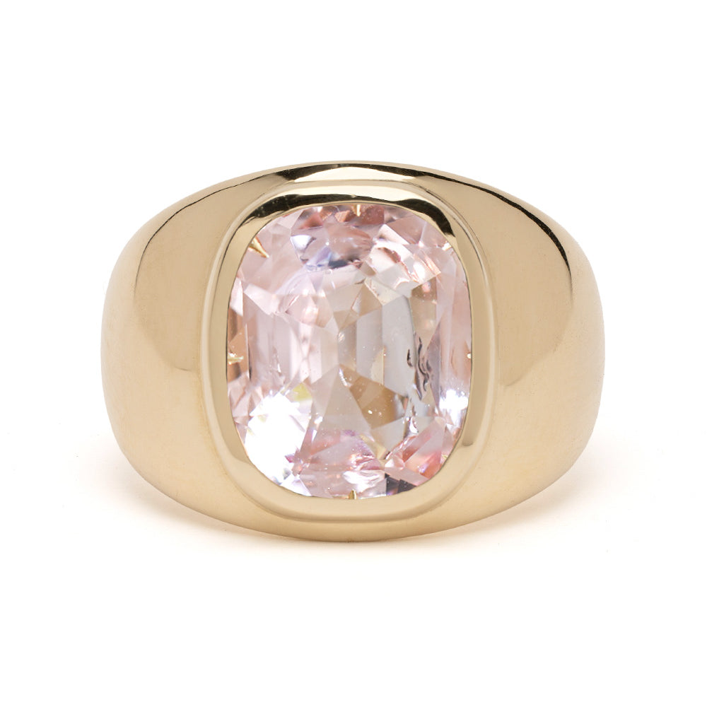 Gold ring with a pink gemstone on a white background
