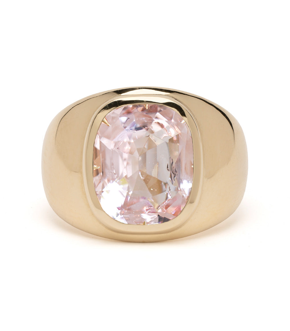 Gold ring with a pink gemstone on a white background