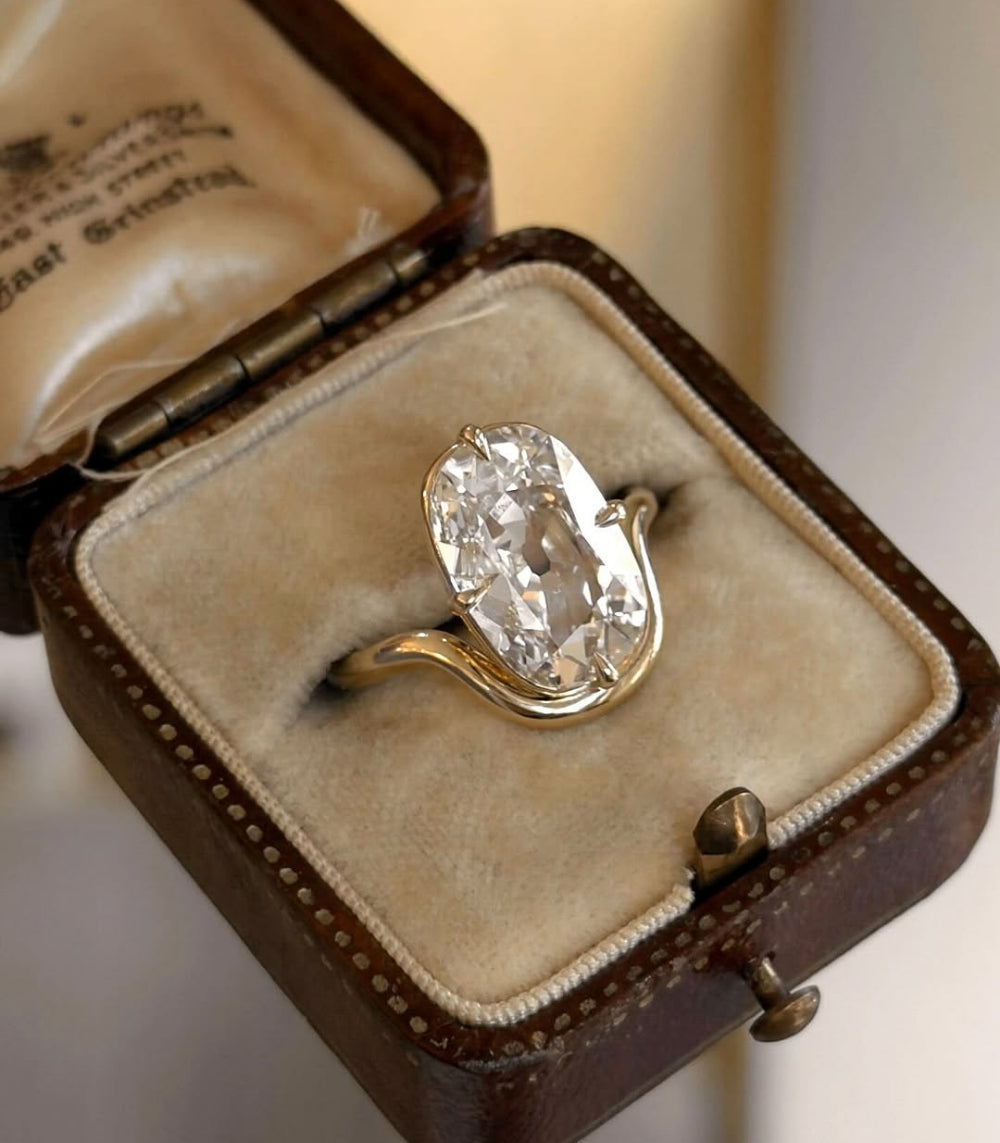 Onda Lite by Sofia Kaman oval diamond gold engagement ring with sculpted bezel on display