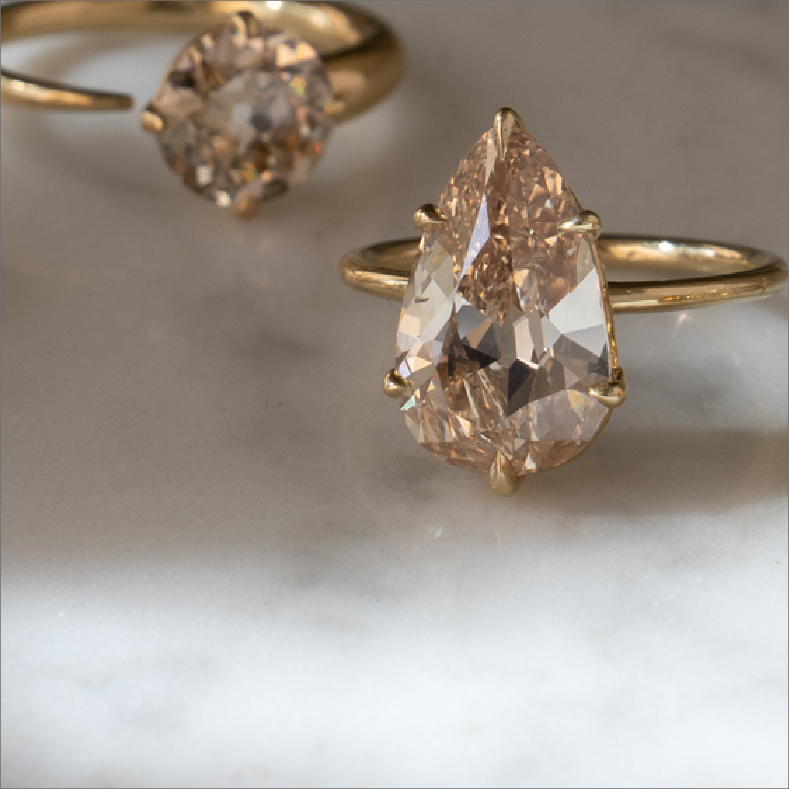 Unique engagement ring with asymmetrical prong-set gold band and a large diamond-like center stone