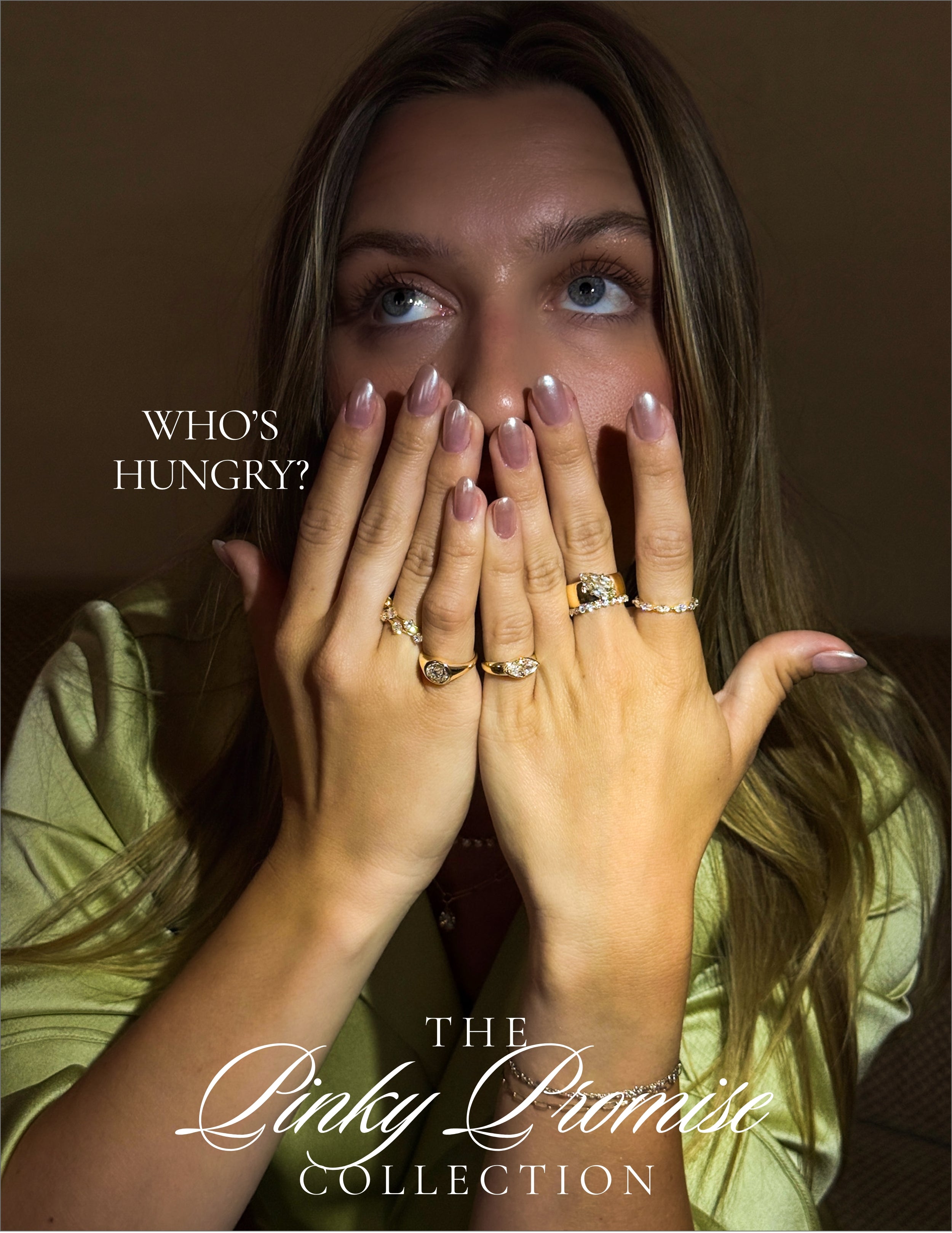 Unique engagement ring with small diamond stones on yellow-gold bands, hands covering face, "WHO'S HUNGRY?"