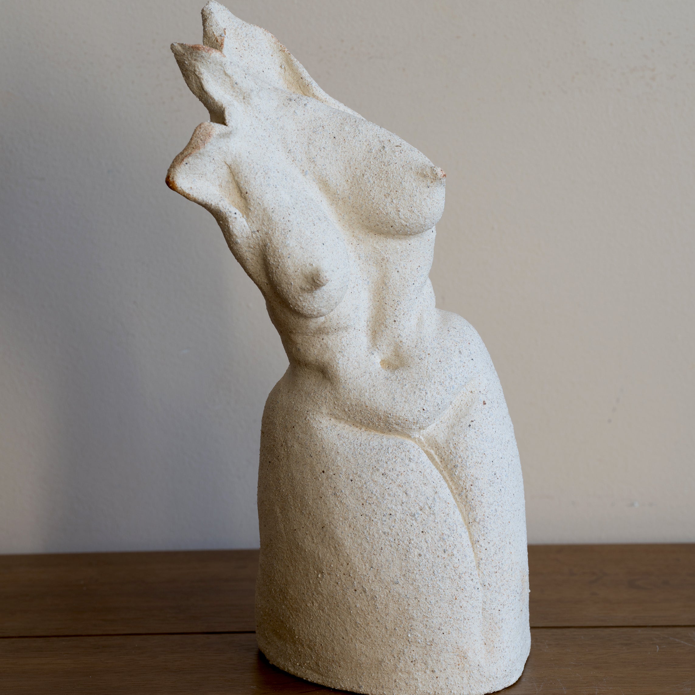 Standing Sculpture I by RM-001, light stone standing figure with smooth carved face on display
