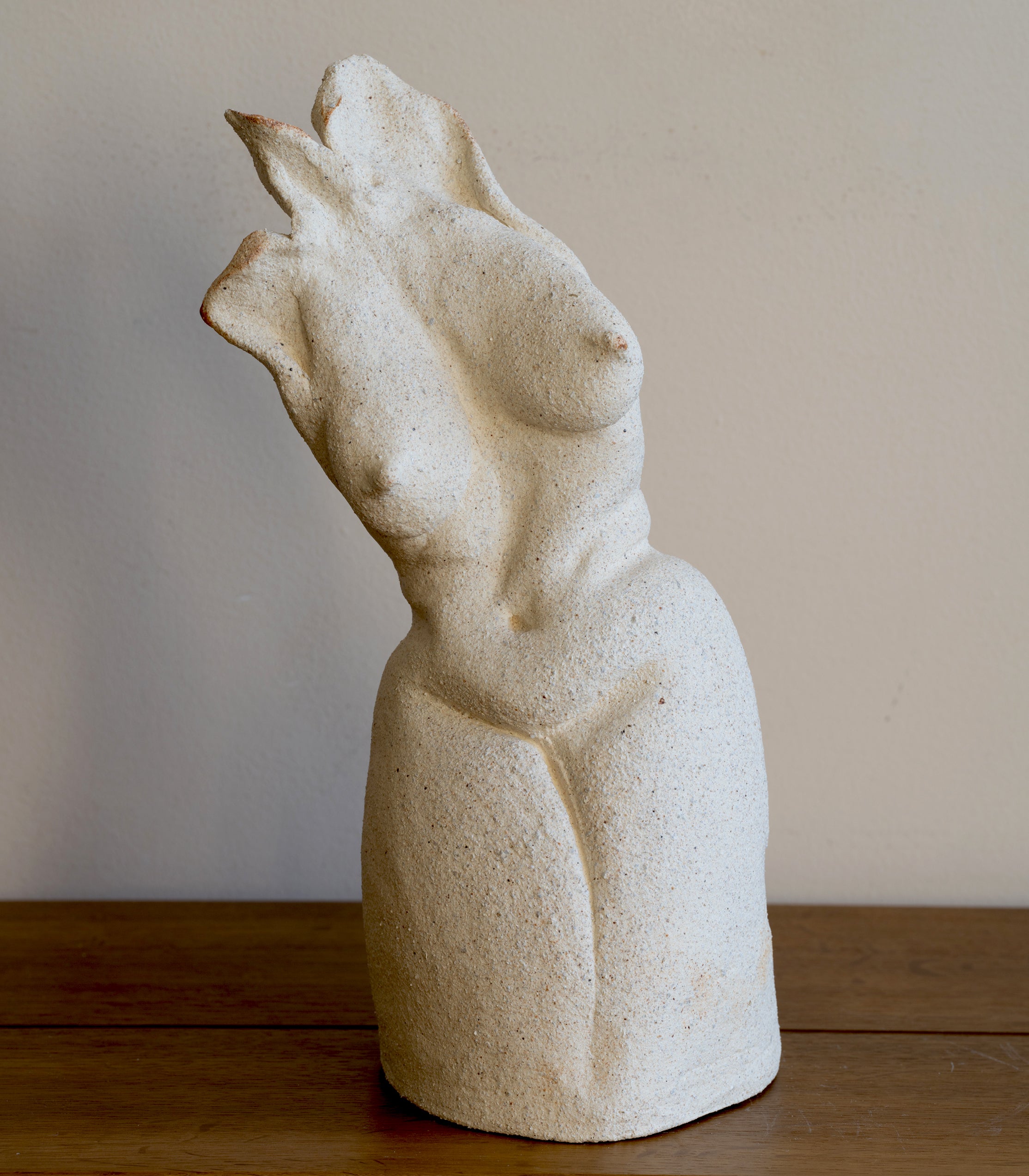 Standing Sculpture I by RM-001, beige stone figurine with carved abstract standing form on wooden floor.