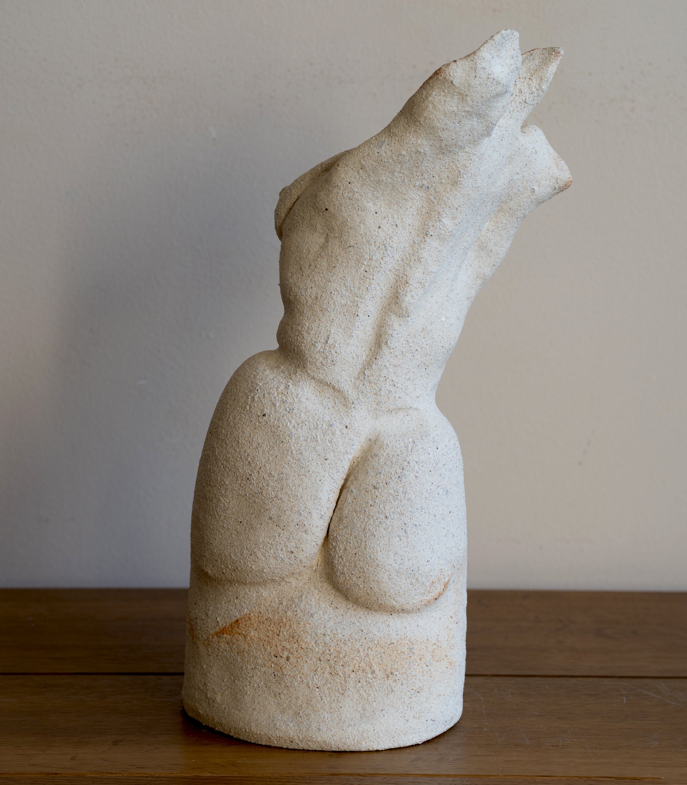 Standing Sculpture I by RM-001 speckled beige stone-look standing figure with curved asymmetrical form