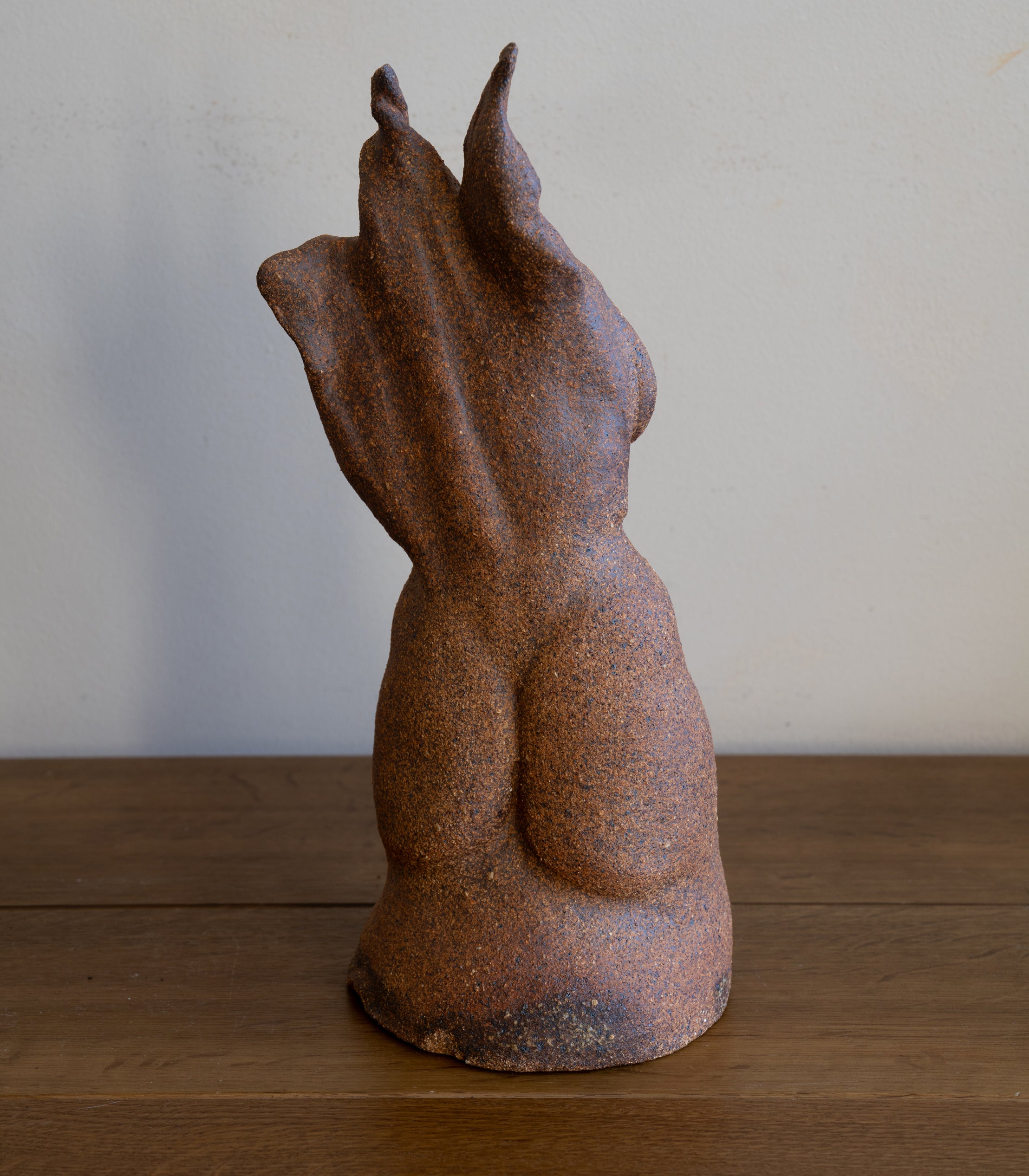 Standing Sculpture II by RM-001, rust-brown speckled stone standing sculpture with blue-gray patina.