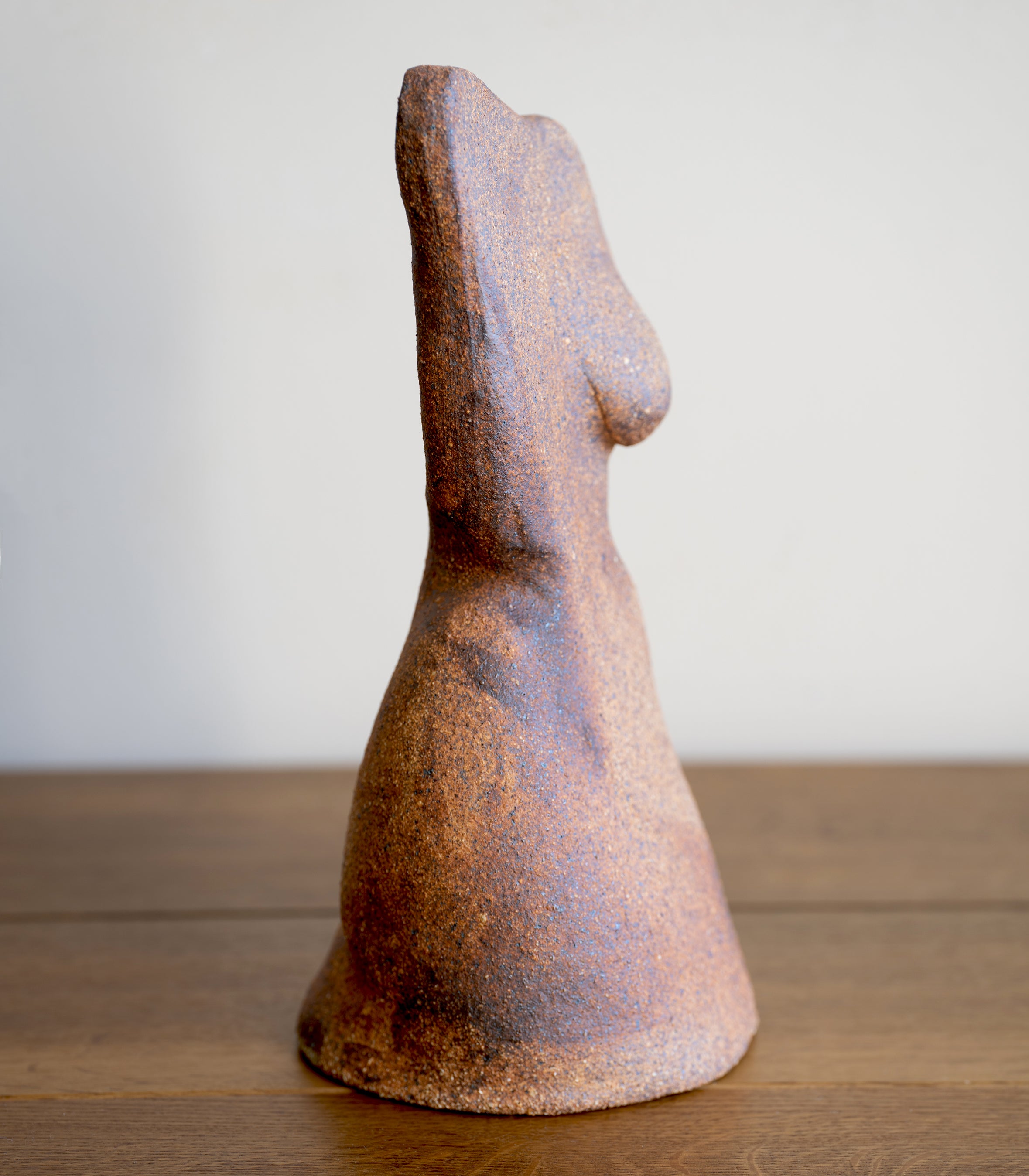 Minimal RM-003 stone sculpture in rust brown and blue with speckled matte texture on display