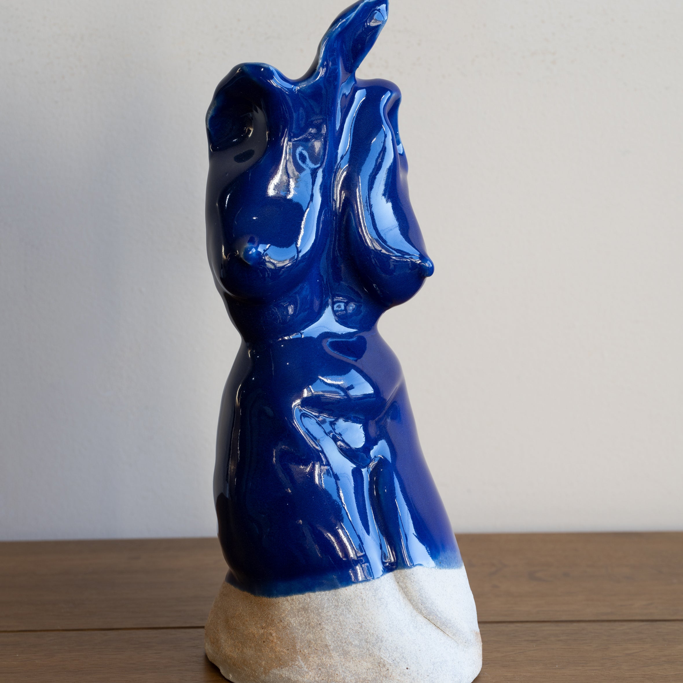 Glazed Sculpture II RM-005 glazed sculpture in glossy blue glaze, figurine with raised arm on stone base