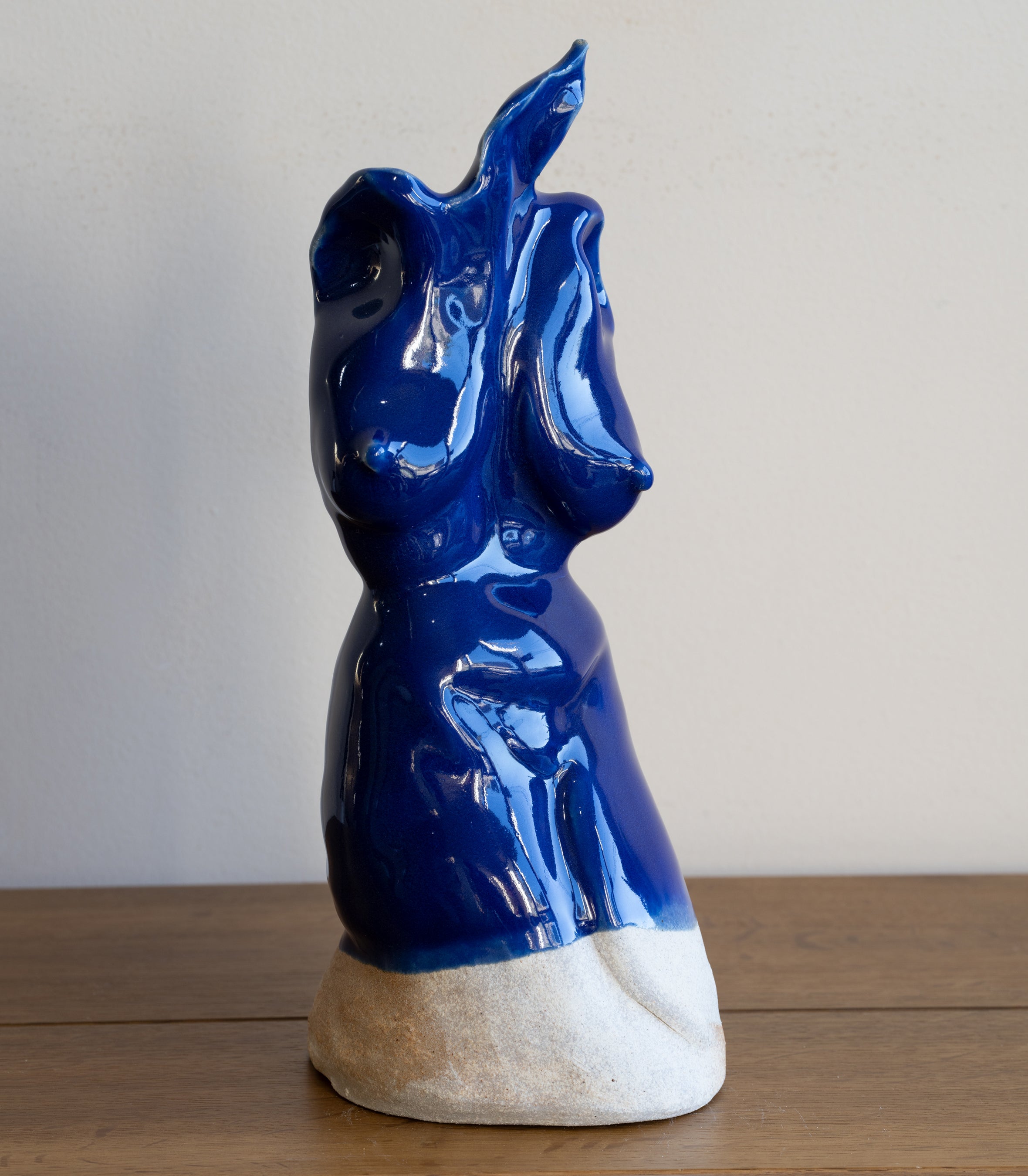 Glazed Sculpture II RM-005 glazed sculpture in glossy blue glaze, figurine with raised arm on stone base