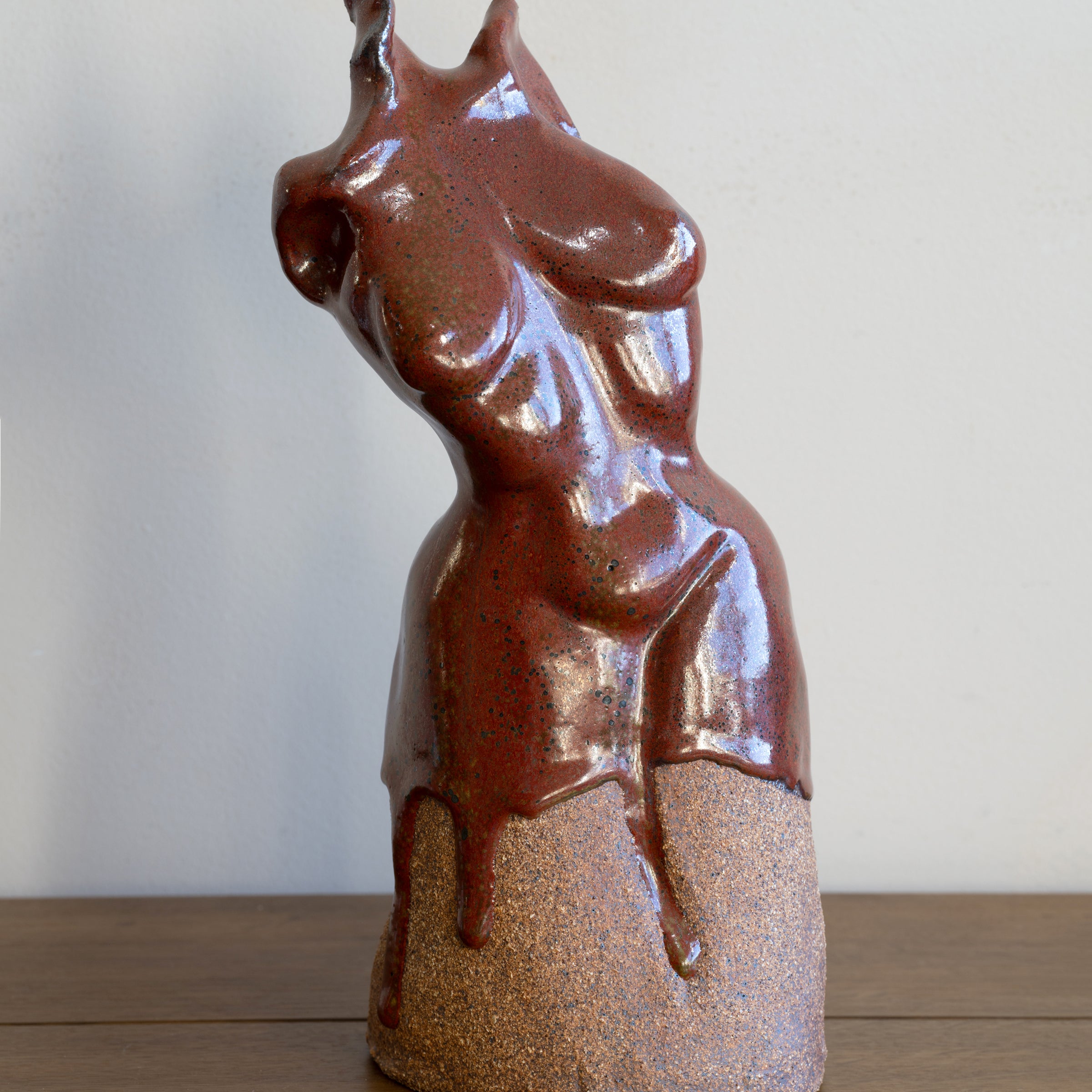 Glazed Sculpture III by RM-005 glossy reddish-brown ceramic sculpture with speckled glaze finish on display