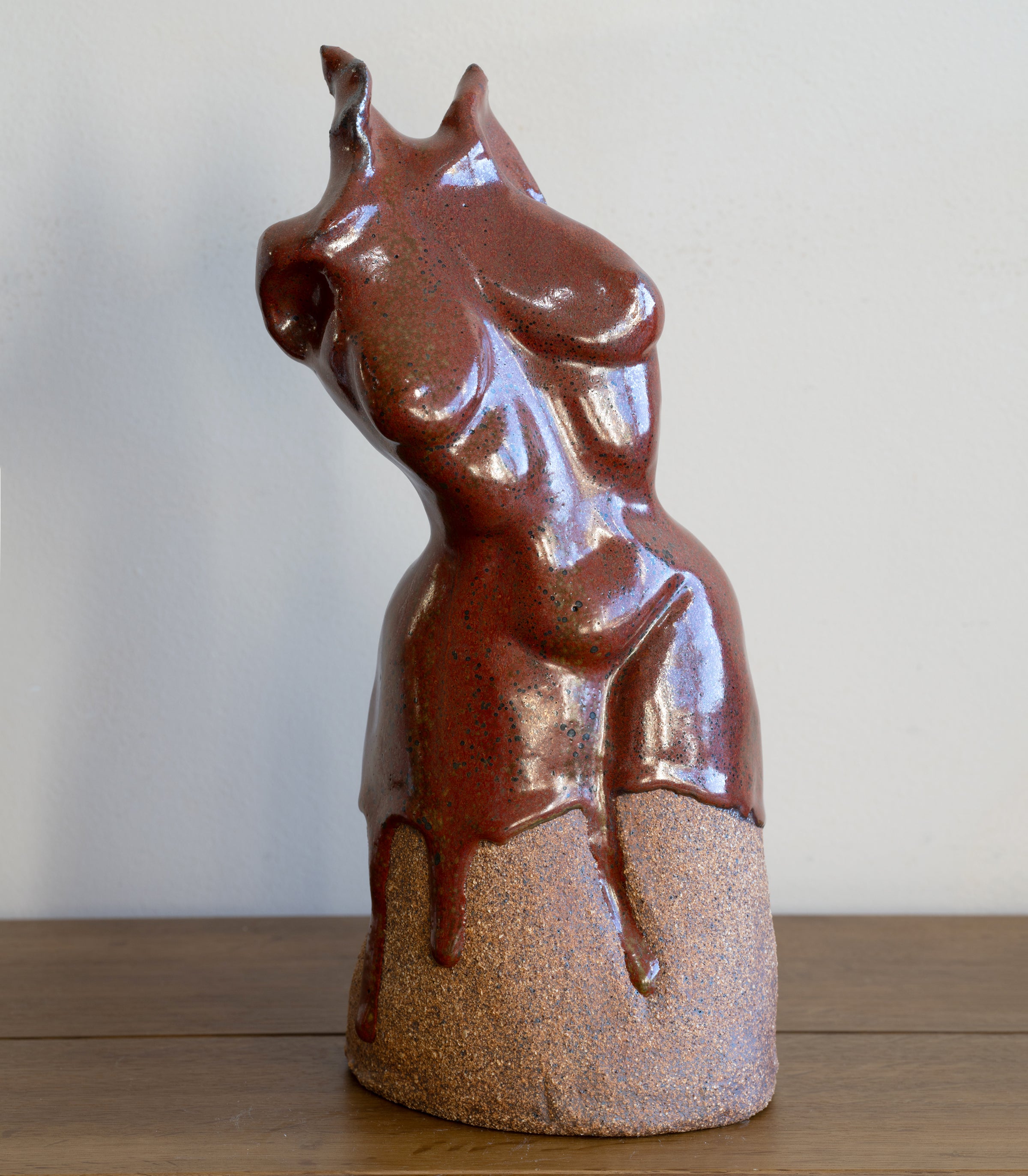 Glazed Sculpture III by RM-005 glossy reddish-brown ceramic sculpture with speckled glaze finish on display