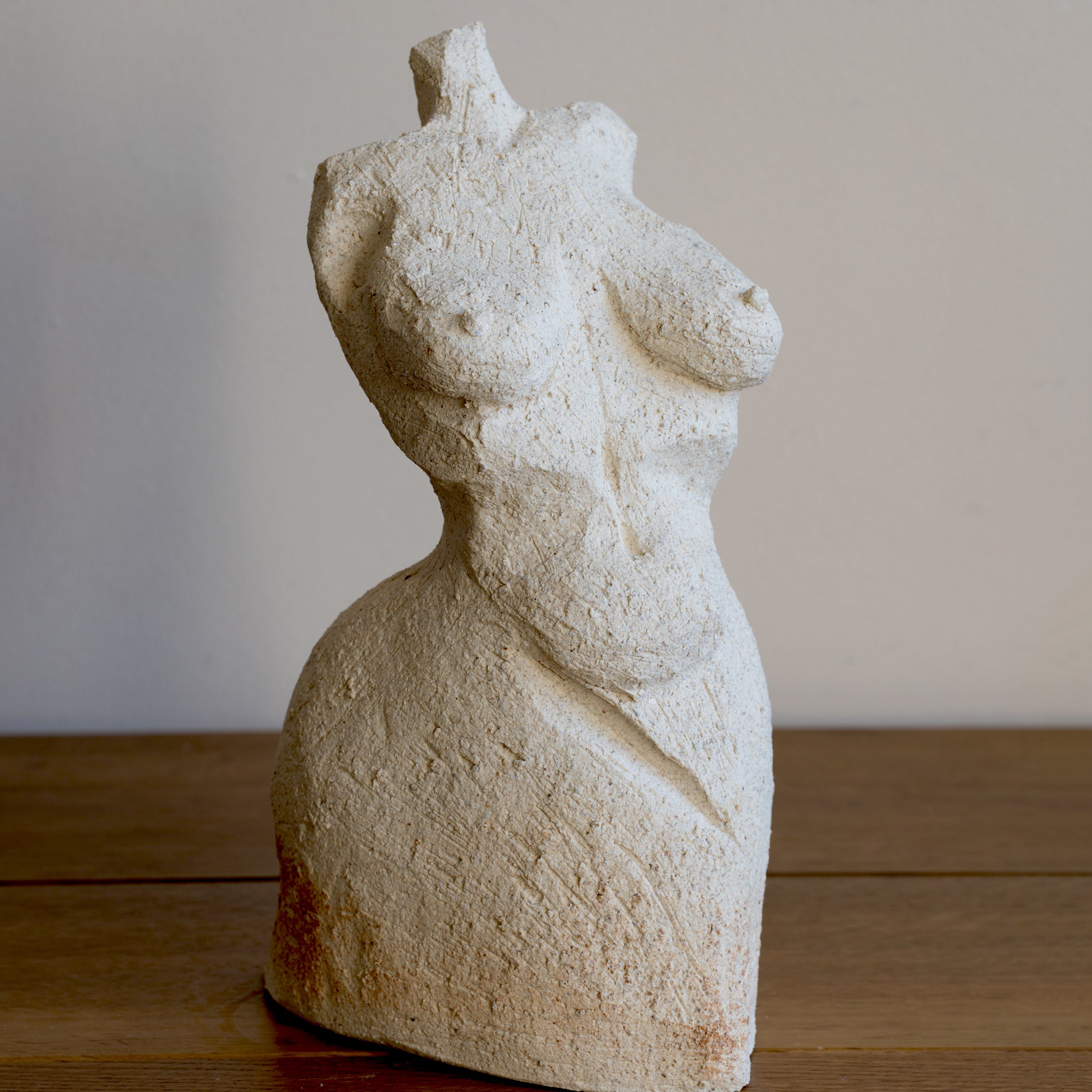 Standing Sculpture III by RM-007, cream stone standing sculpture with textured carved surface, on wooden floor