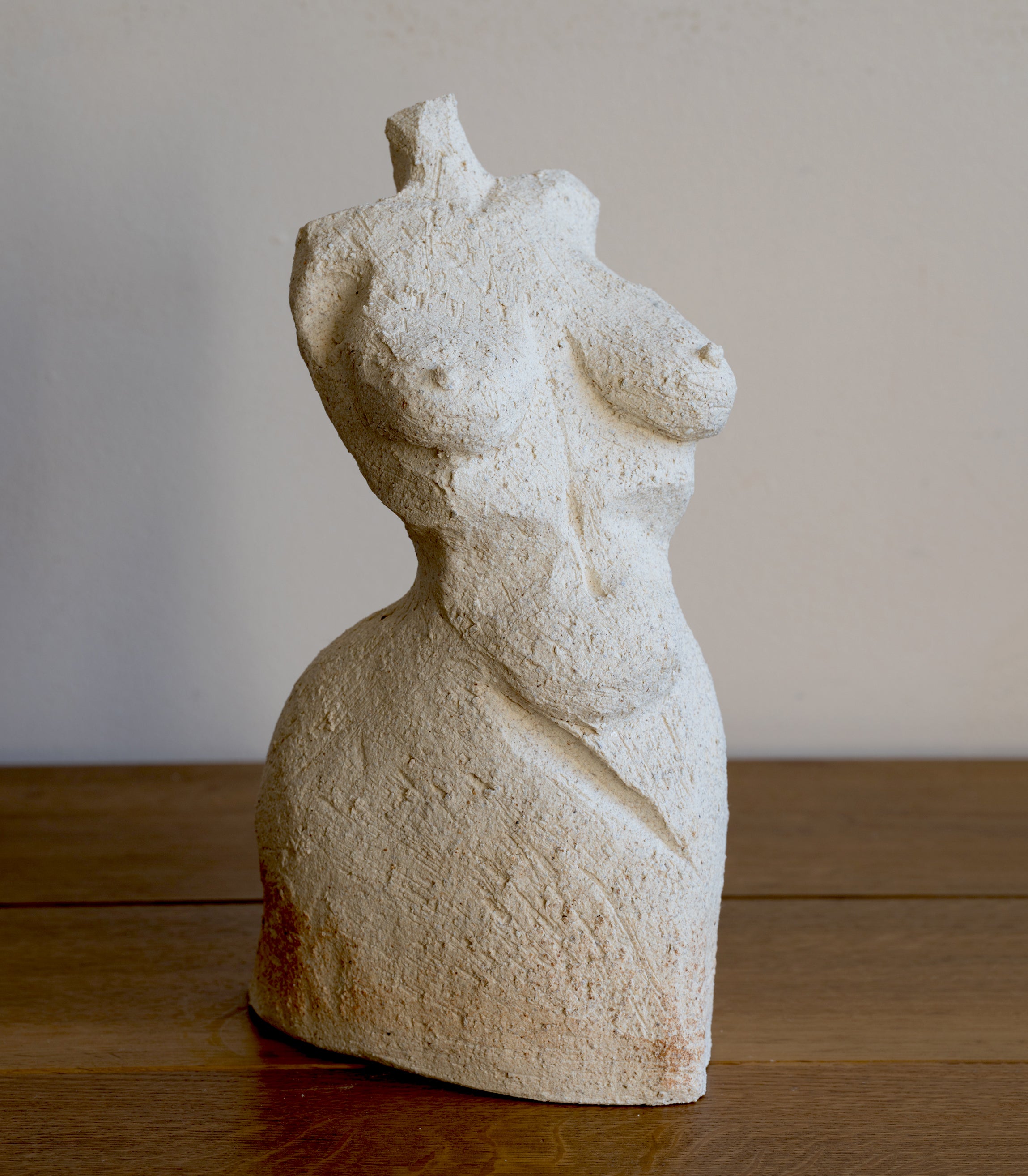 Standing Sculpture III by RM-007, cream stone standing sculpture with textured carved surface, on wooden floor