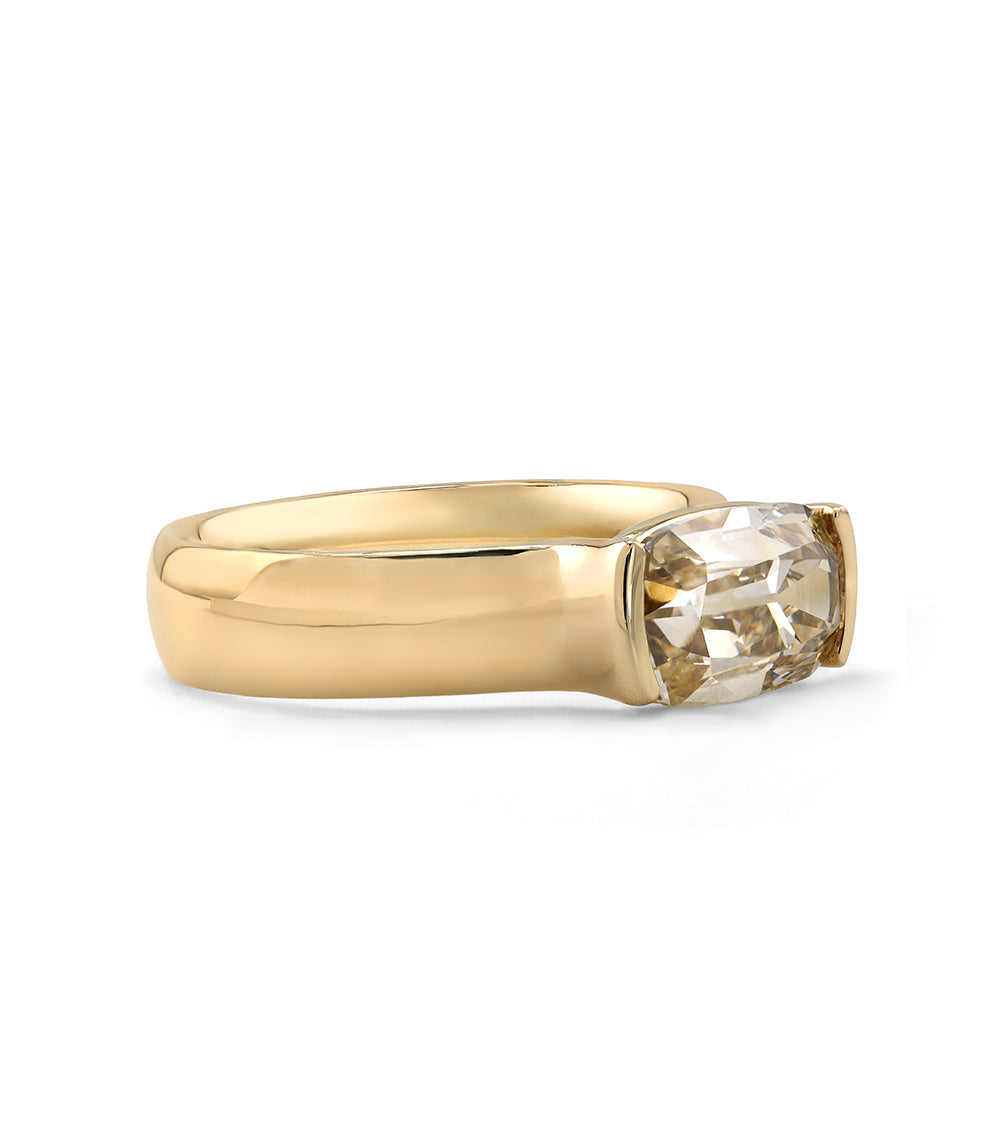 side view of a old mine cut elongated cushion champagne lab diamond ring set east west in a half bezel with a thick 14K yellow gold band 