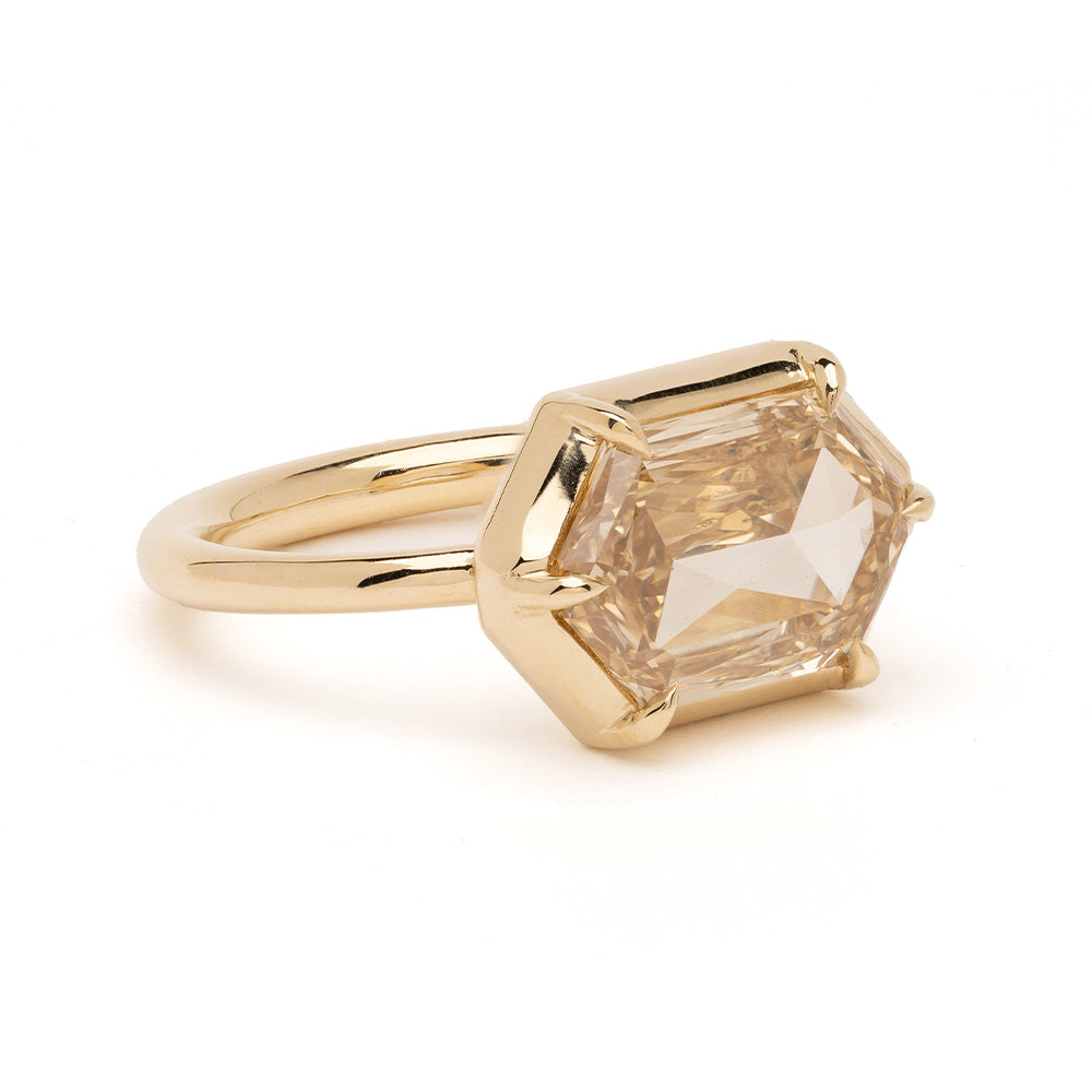 Cora Sofia Kaman unique engagement ring in yellow gold with a faceted geometric center stone