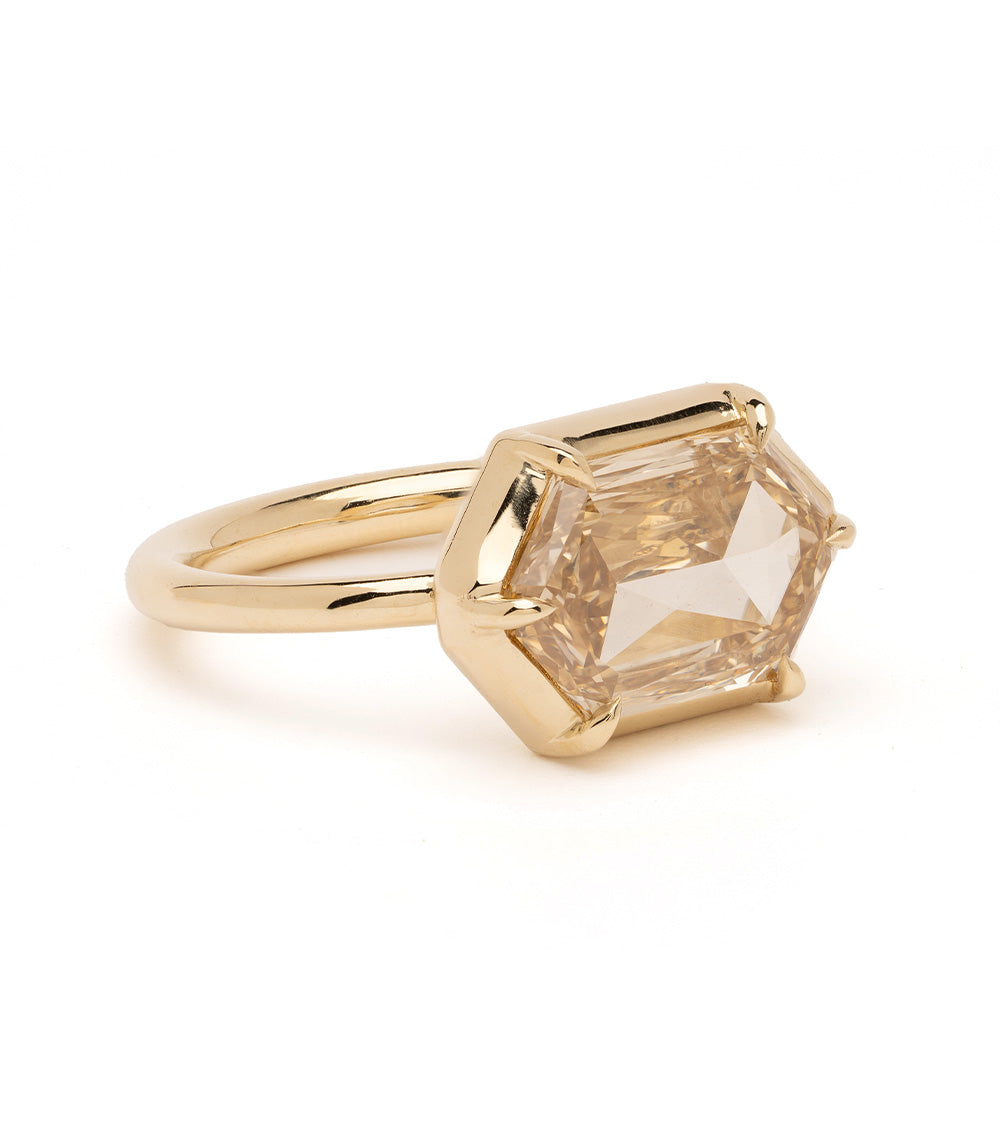 Cora Sofia Kaman unique engagement ring in yellow gold with a faceted geometric center stone