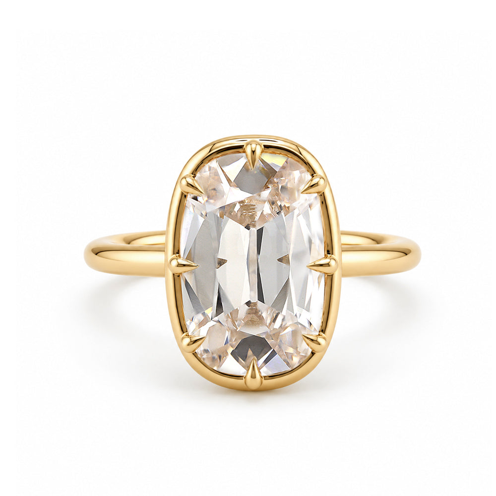 champagne colored old mine cut elongated cushion lab diamond in an antique style setting with claw prongs in 14K yellow gold