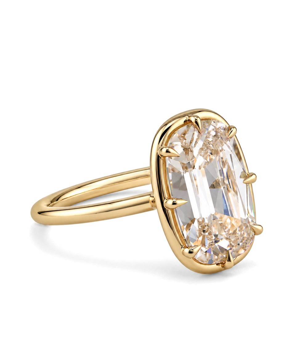 side view of a champagne colored old mine cut elongated cushion lab diamond in an antique style setting with claw prongs in 14K yellow gold