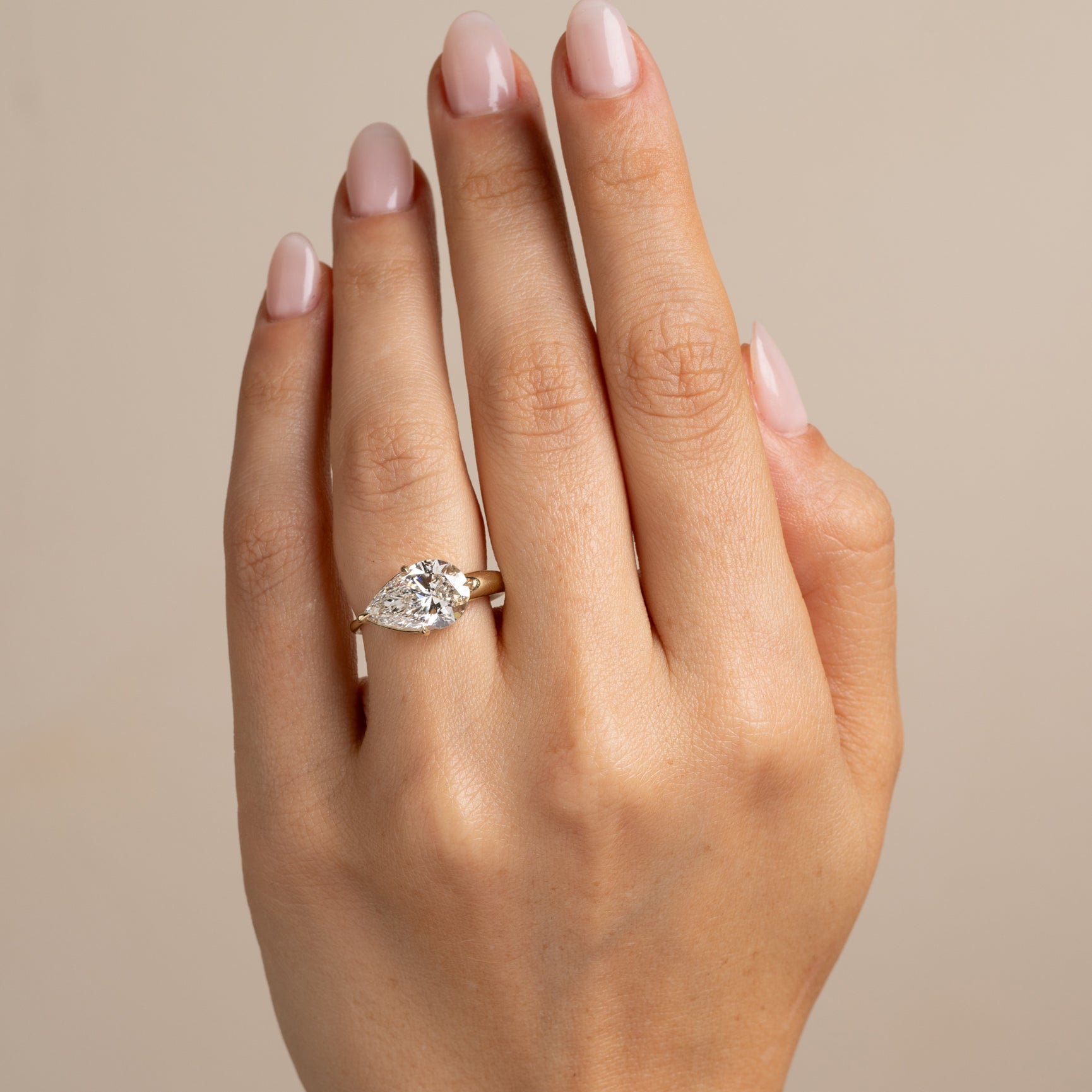 Sloane SK-R86-EW-LGD-PB-3.59 gold engagement ring with round diamond solitaire on finger