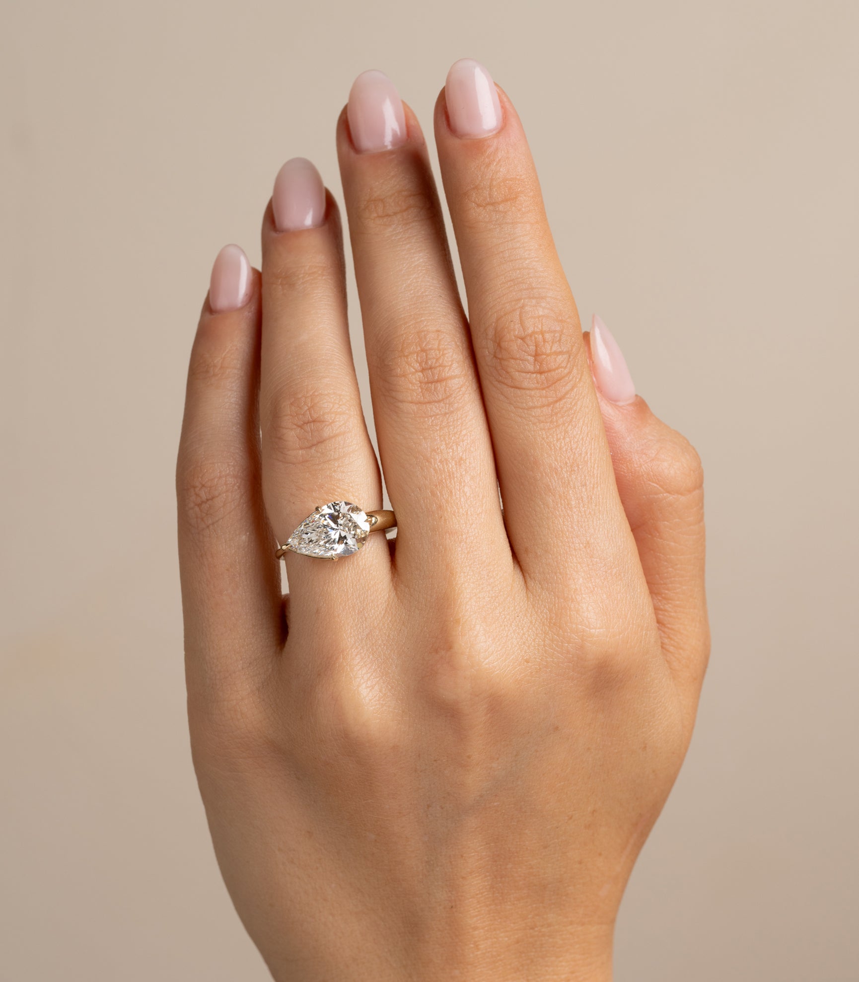 Sloane SK-R86-EW-LGD-PB-3.59 gold engagement ring with round diamond solitaire on finger