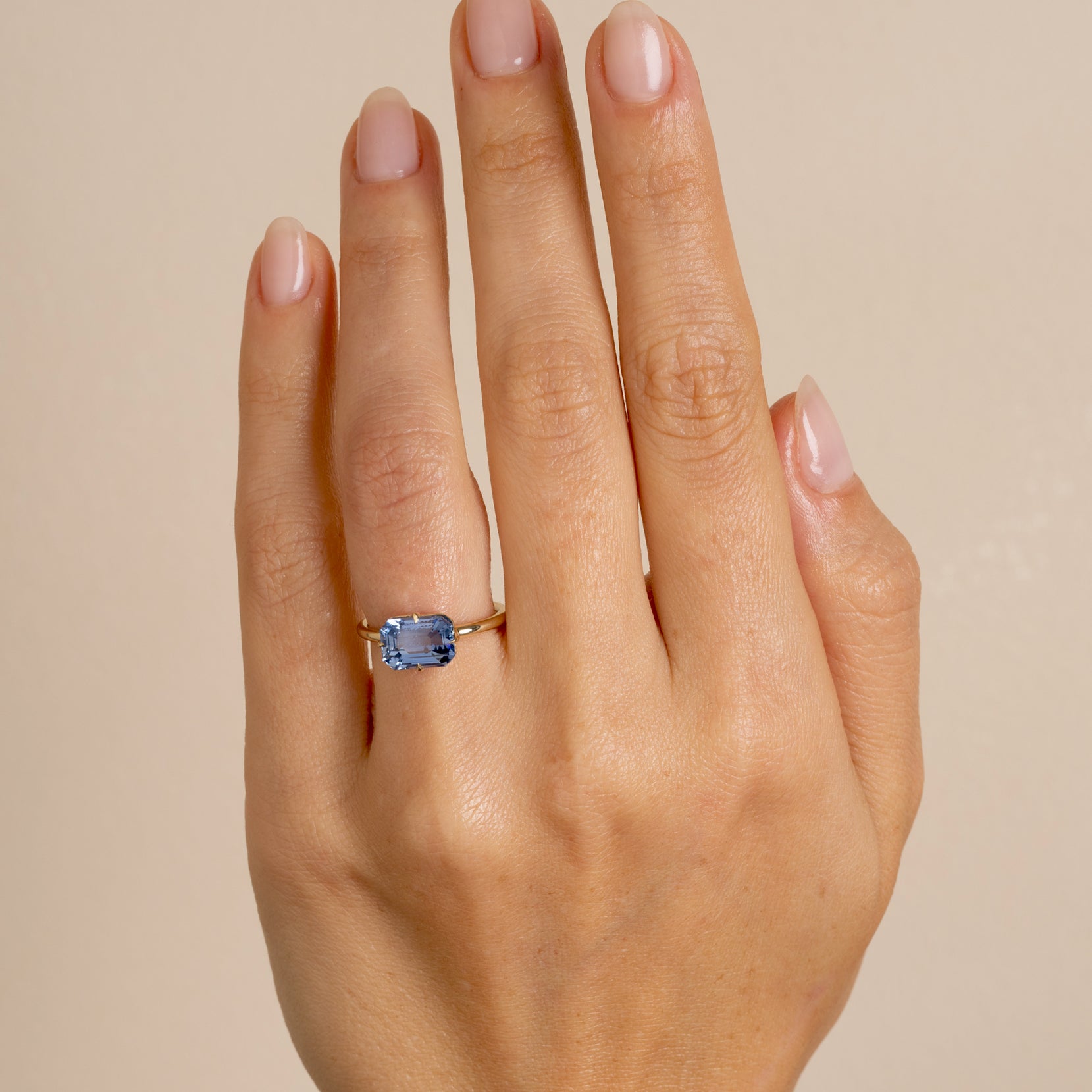 Billie SK-R94-BS-EW-EC-3.00 understated engagement ring in gold with a blue cushion-cut stone